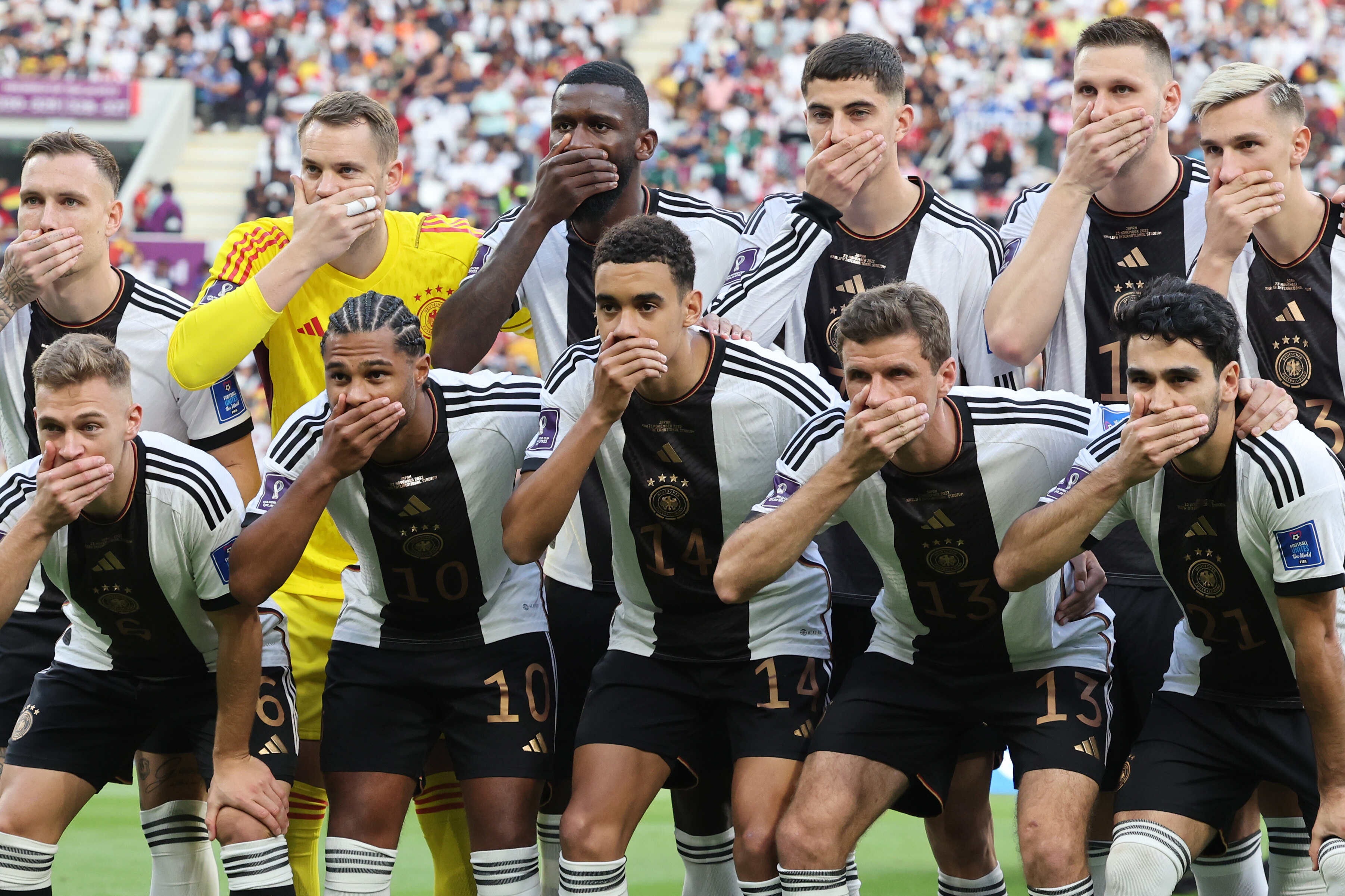 German football players cover their mouths as they pose for a team photo before the start of the FIFA World Cup Qatar 2022 soccer match between Germany and Japan at Khalifa International Stadium. Photo: DPA