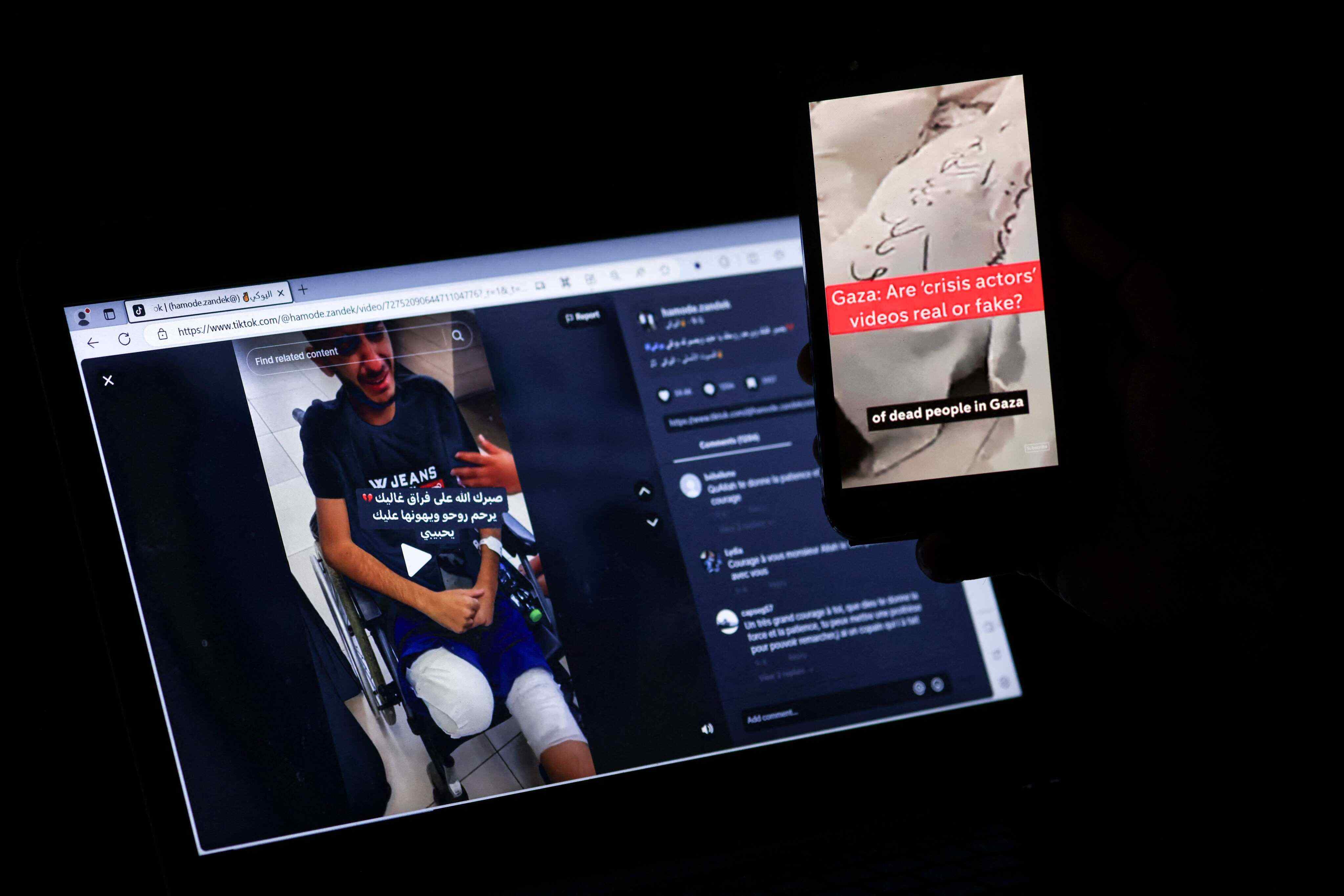 This photo illustration taken in Jerusalem on November 10, 2023 shows a person watching a computer screen (L) displaying content of an amputee spread over social media amid a disinformation campaign downplaying the horrors of the Israel-Gaza war. Photo: AFP