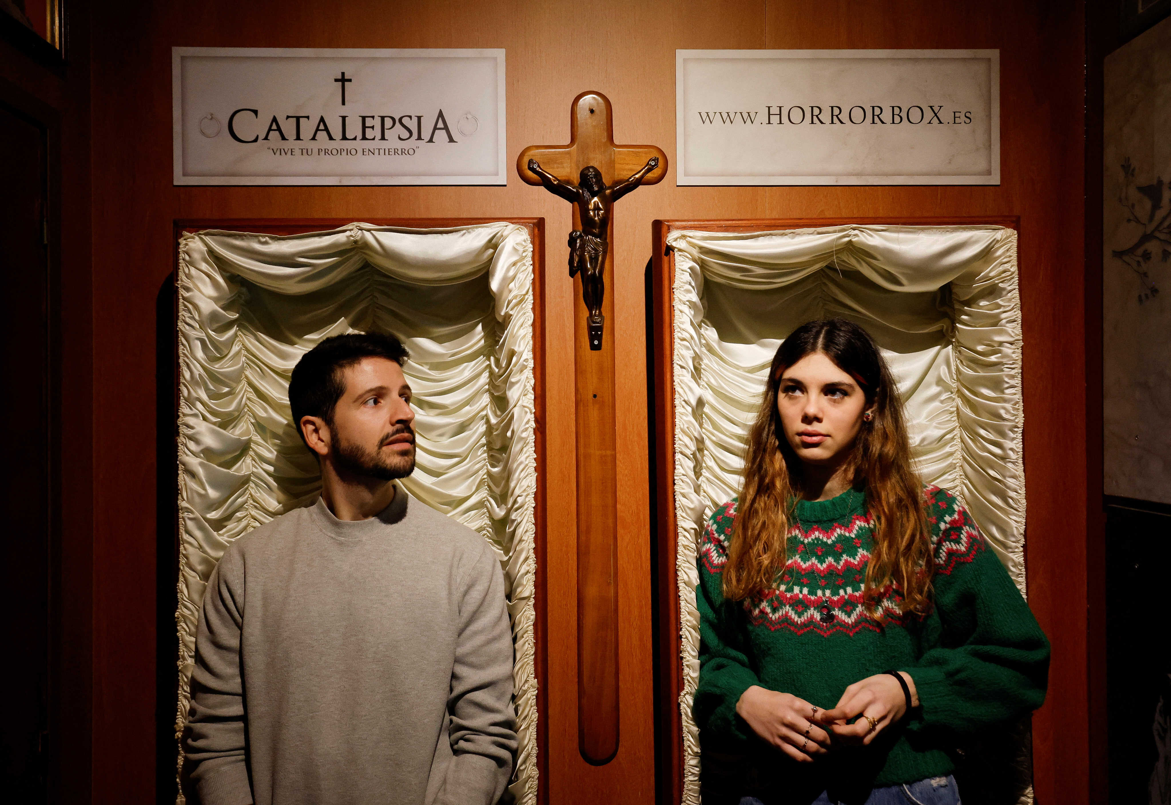 A couple of gamers, Miriam Castella and Carlos Granedo, participate in an extreme escape room, which takes place inside two coffins. Photo: Reuters