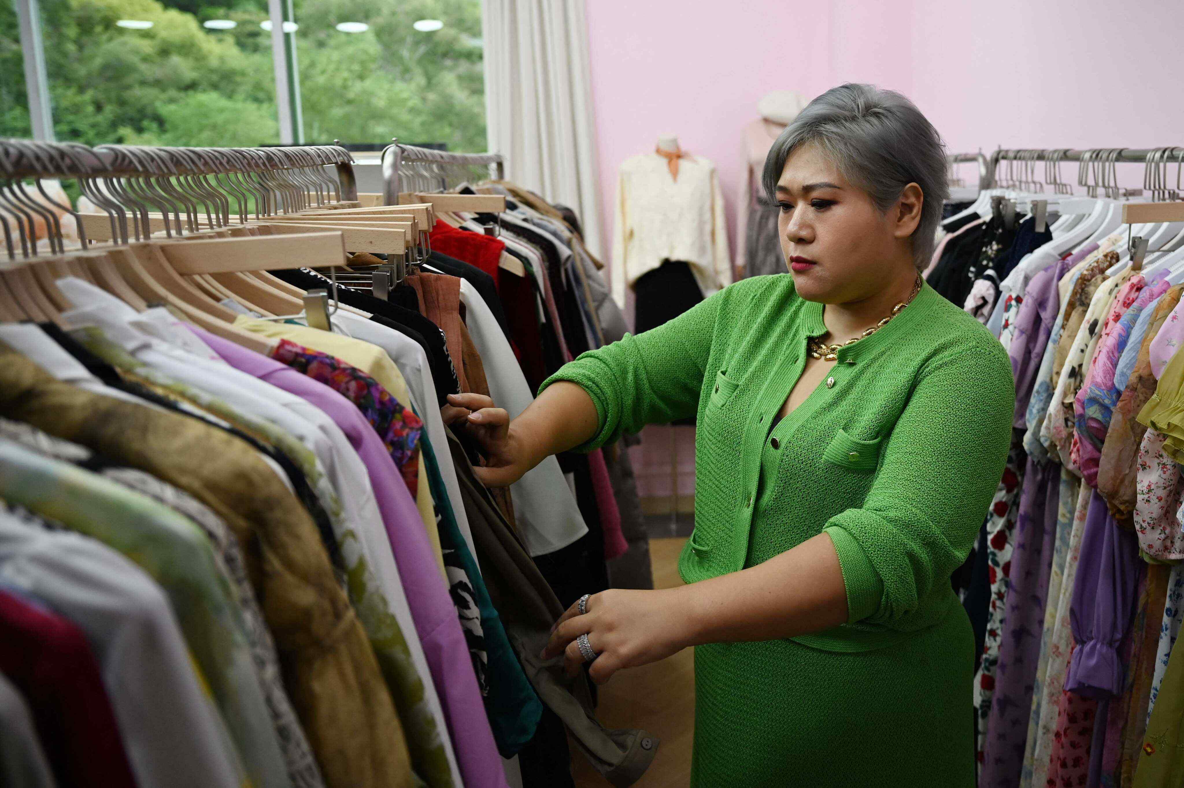 Brand owner and influencer Amanda Yao inspects clothes in her office in Guangzhou. Photo: AFP