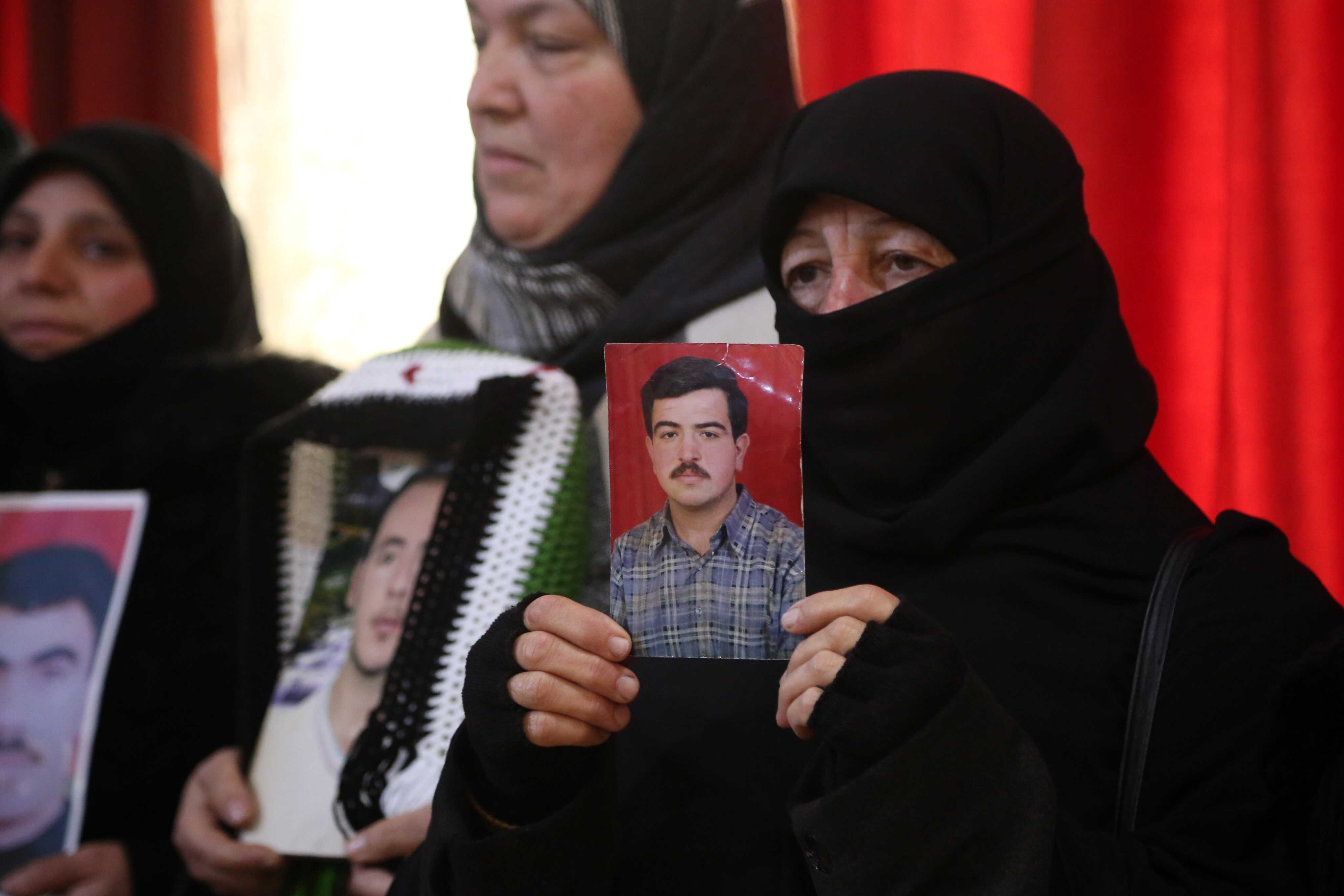 Syrian women hold portraits of their missing loved ones during a protest march demanding justice for persons detained and disappeared by the al-Assad regime. Photo: EPA-EFE