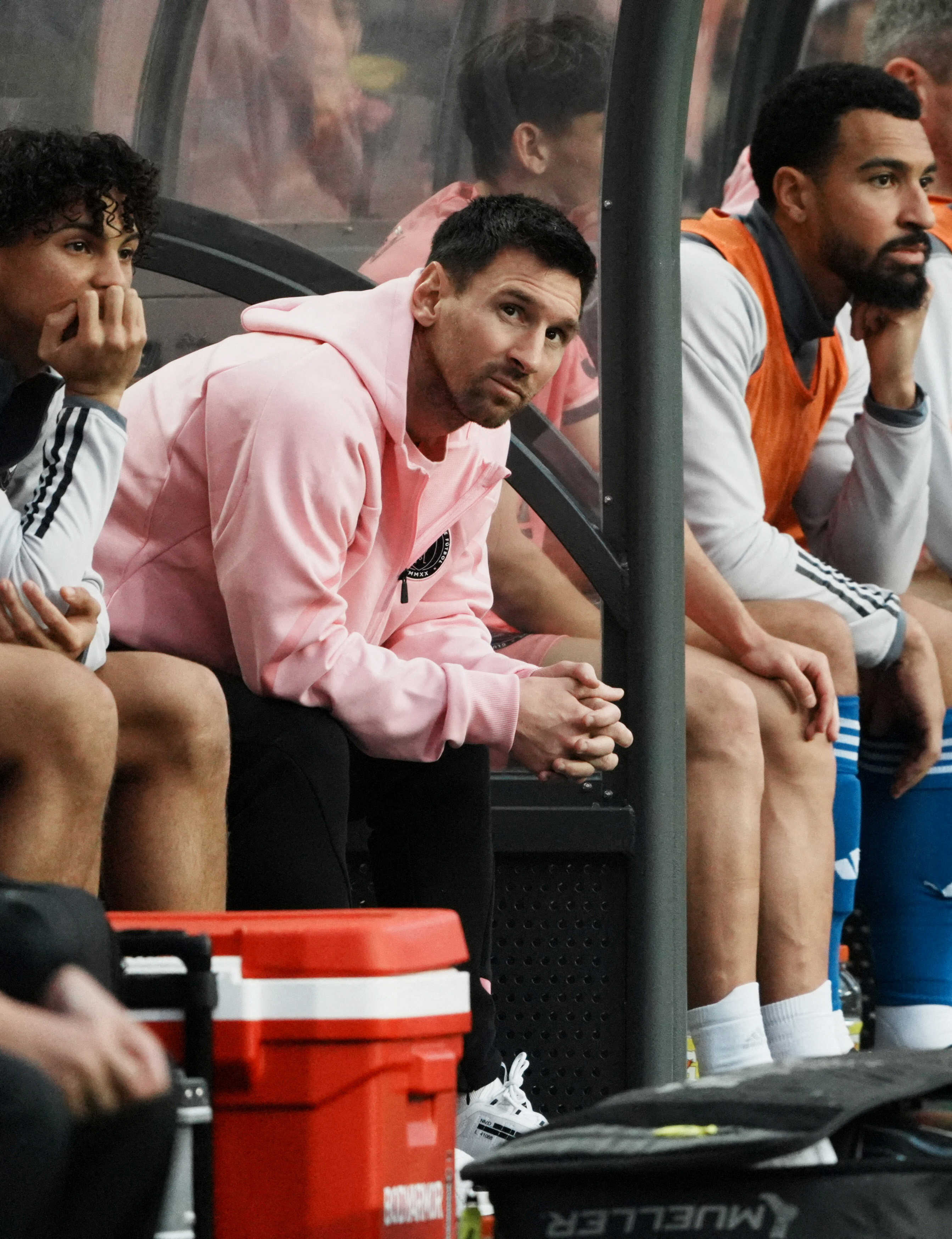 Lionel Messi looks on from the substitutes bench during a football friendly match he sat out on in Hong Kong. Photo: Reuters