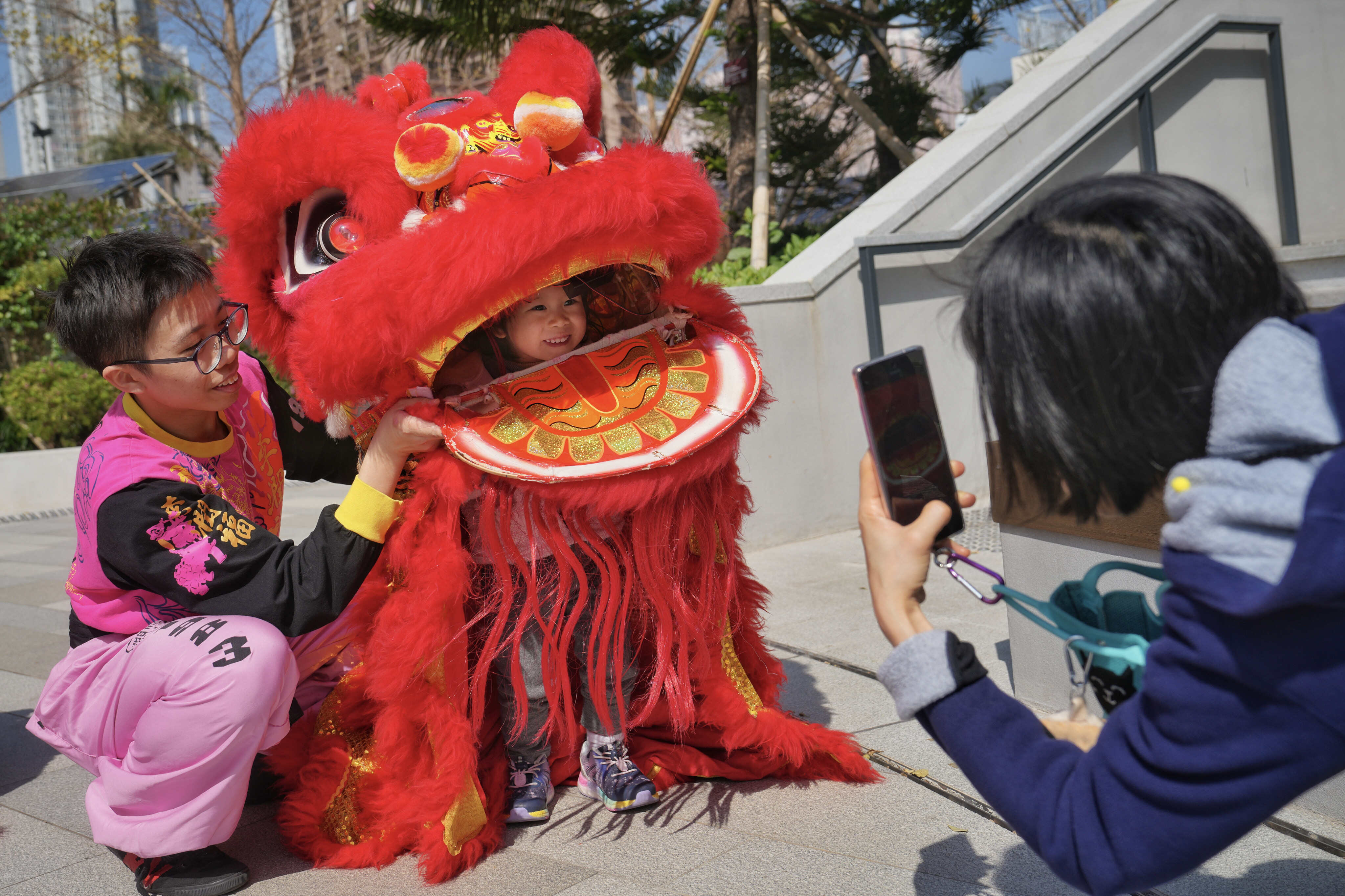 Children experience lion dancing in a Lunar New Year fun fair at a shopping centre in Tsuen Wan. Photo: Elson Li