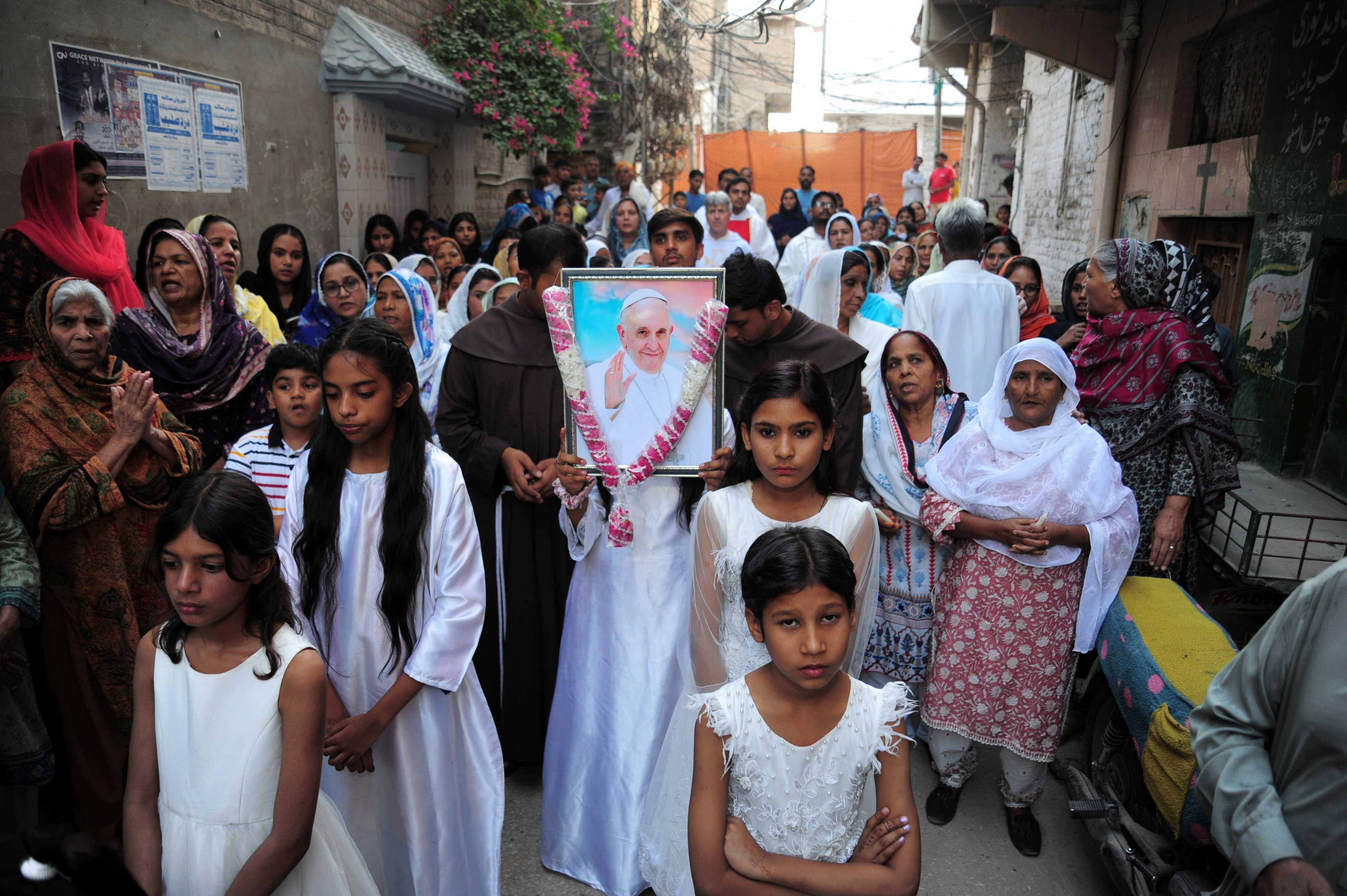 Members of the Christian community carry a portrait of the late Pope Francis during a mass in his honour at St Joseph Catholic Church in Hyderabad, Pakistan. Photo: EPA-EFE