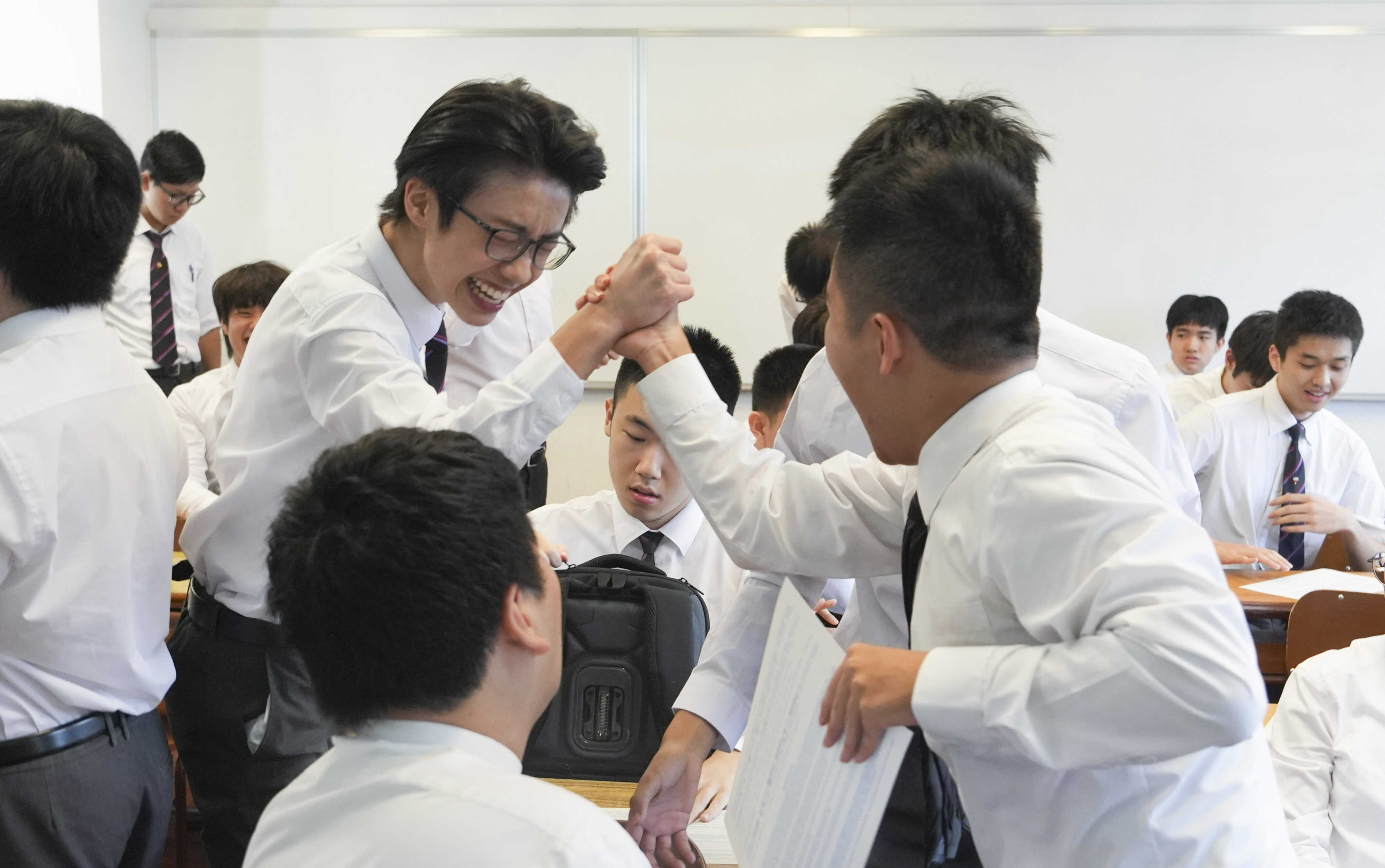 Students at La Salle College in Kowloon Tong react to their DSE results on Wednesday morning. Photo: Sun Yeung