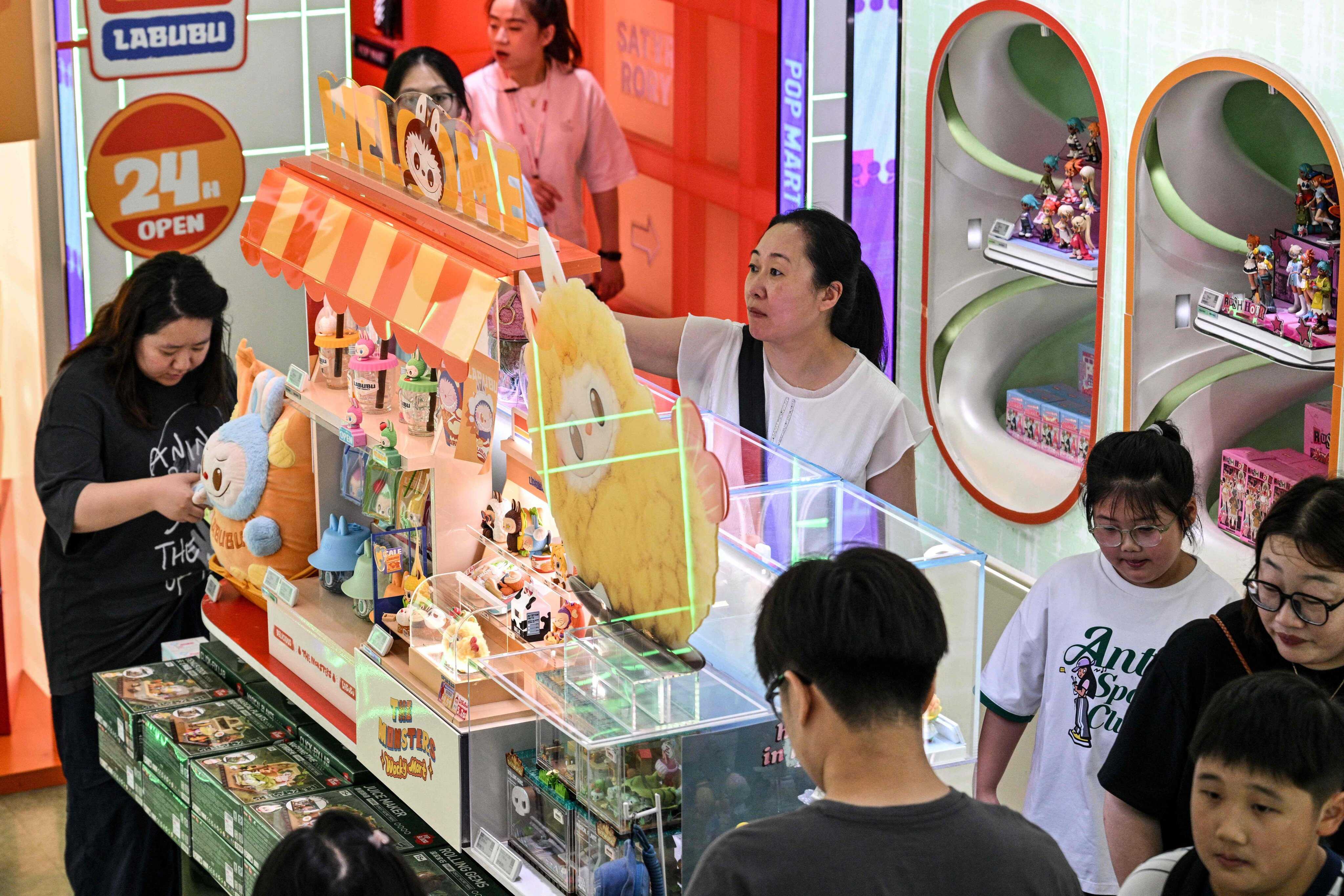 Customers look at toys in a Pop Mart in Shanghai, China. Photo: AFP
