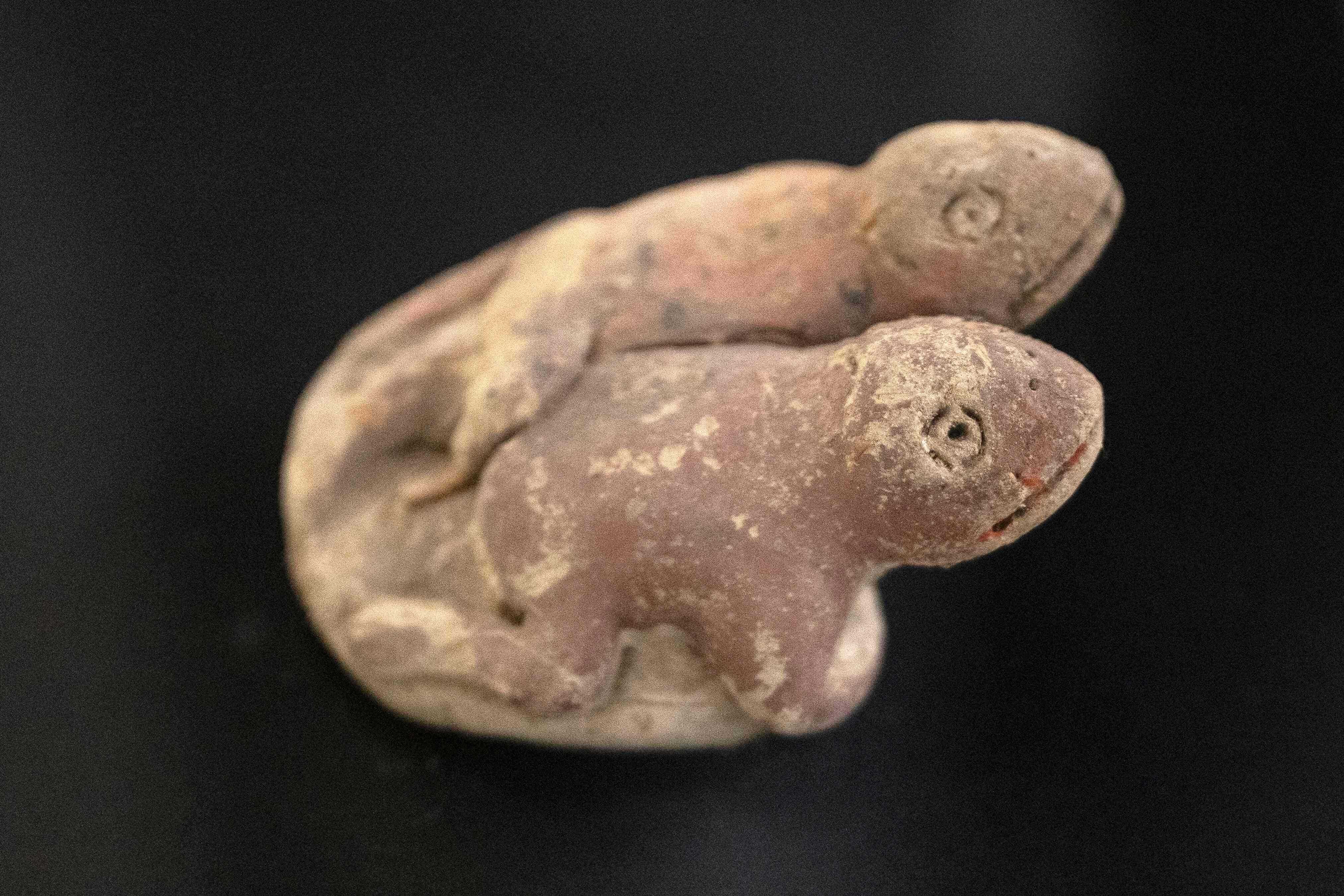 A sculpture depicts two toads, a symbol associated with the arrival of rains. Photo: AFP