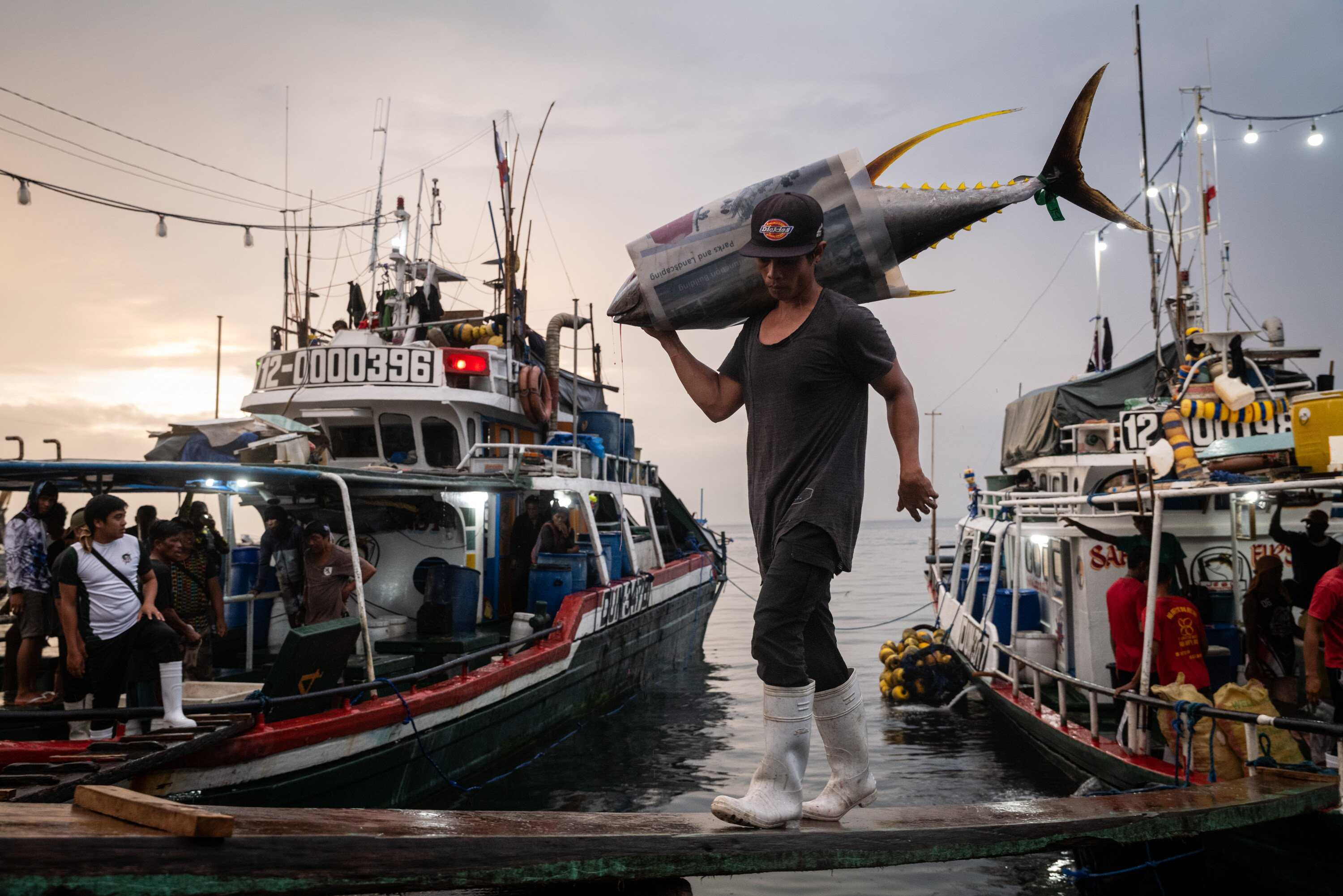 Filipino fishermen unload catches after being at sea for about one month, at General Santos fish port in the Philippines. Photo: Nicole Tung