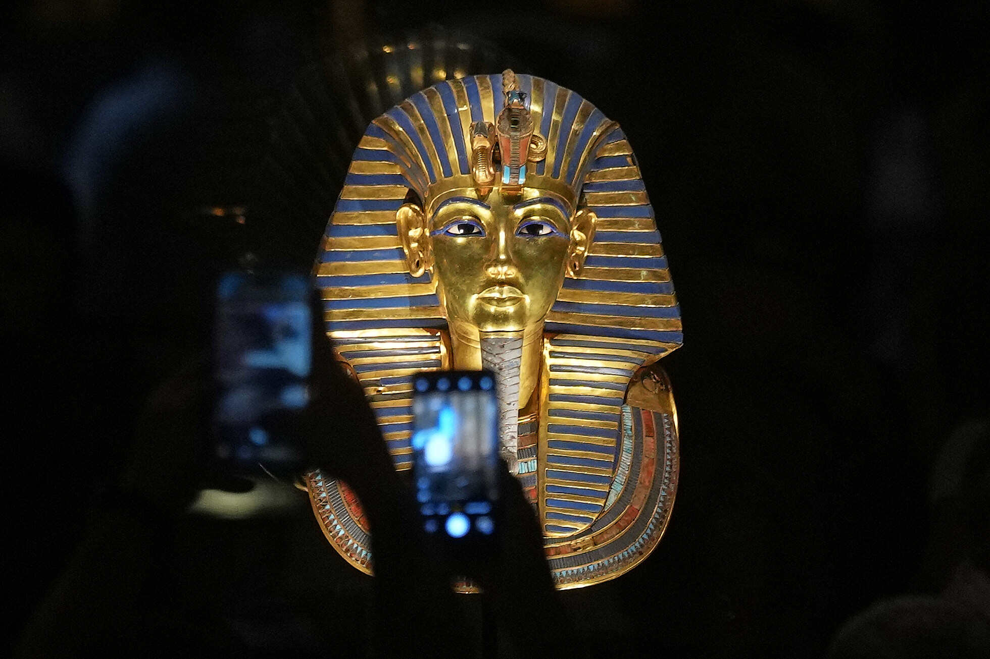 Visitors take photos of the golden burial mask of King Tutankhamun after the official opening of the Grand Egyptian Museum. Photo: AP 