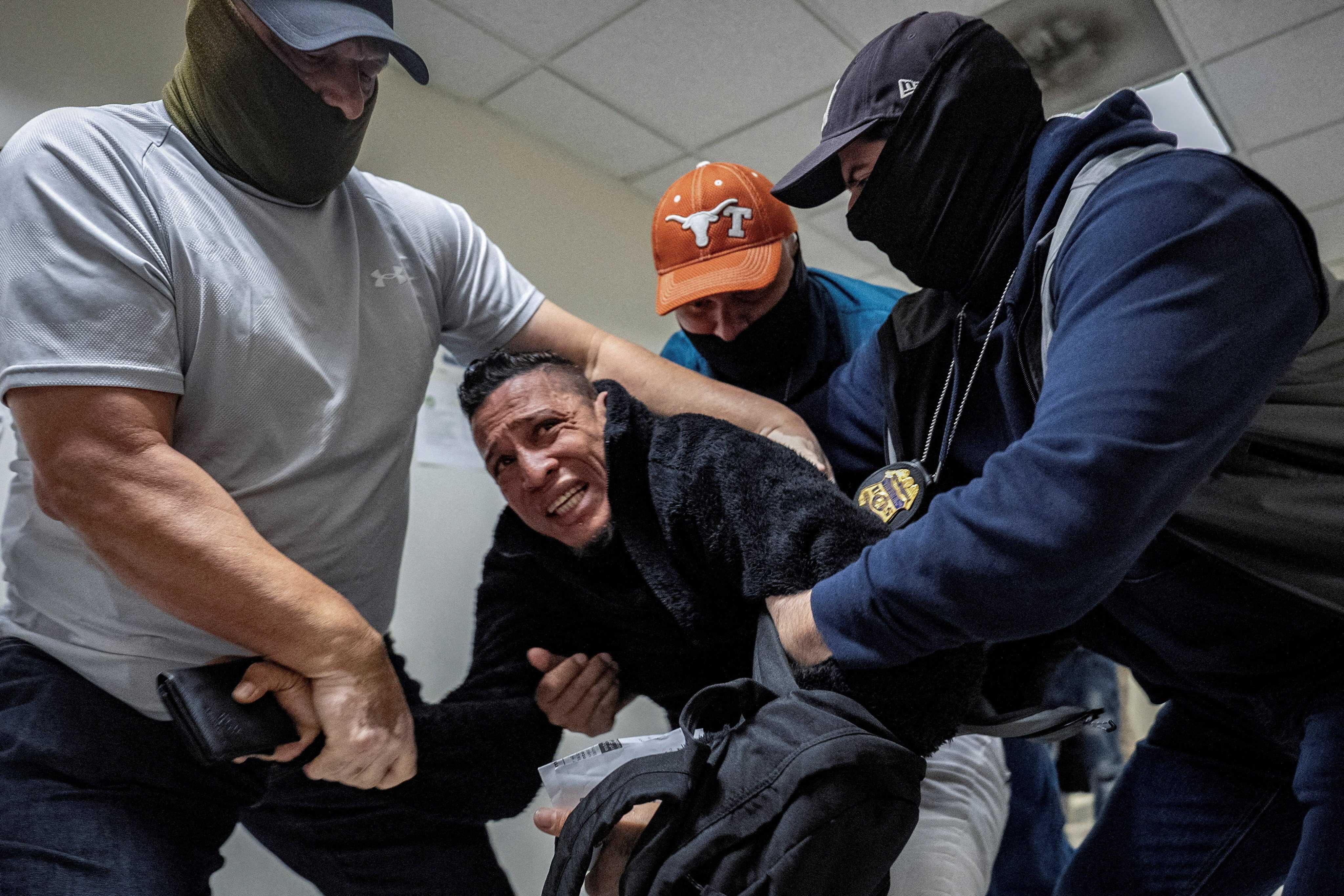 United States Immigration and Customs Enforcement (ICE) agents and federal officers detain a migrant as he walks out from a hearing at a US immigration court in Manhattan, New York. Photo: Reuters