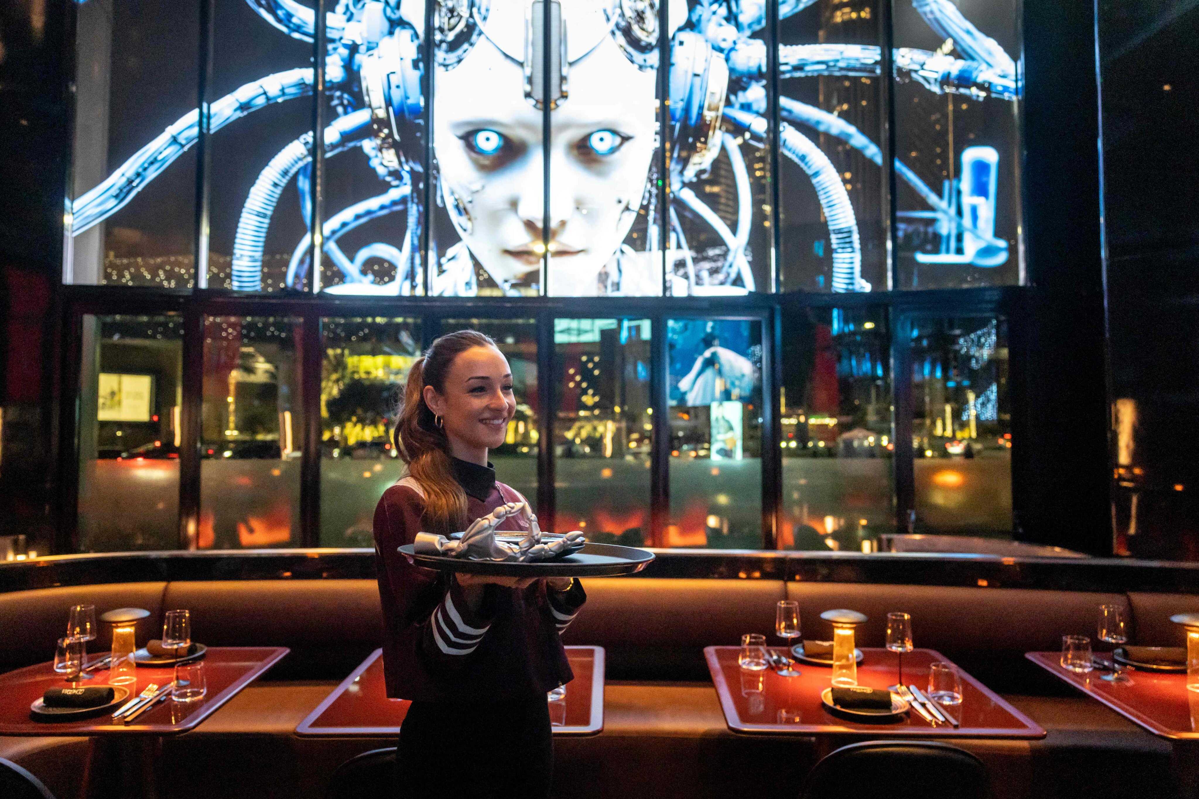 A waitress holds a serving tray at Woohoo, an AI-powered restaurant in Dubai. Photo: AFP