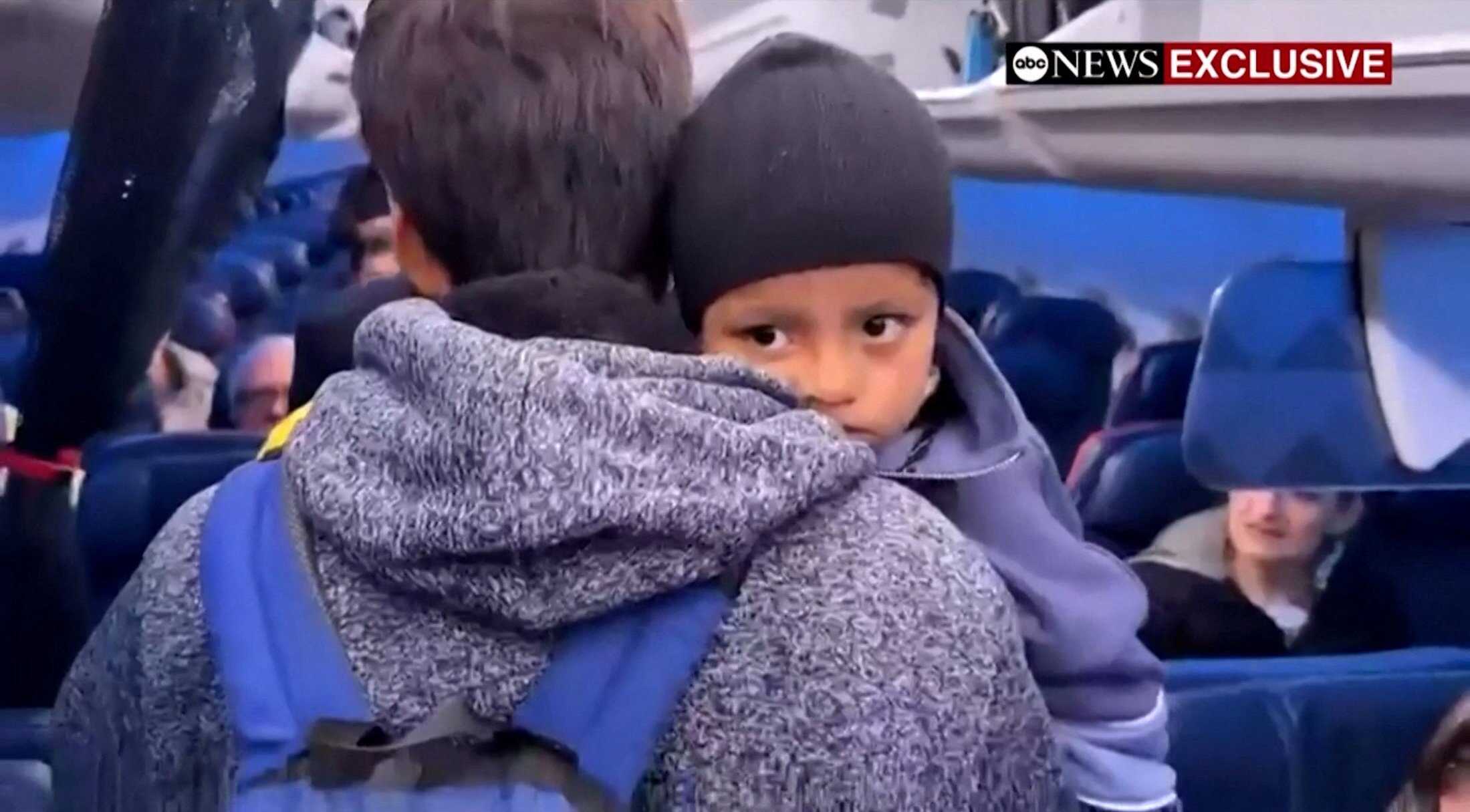 Liam Conejo Ramos is held by his father, Adrian Alexander Conejo Arias, while boarding an aircraft to return to Minneapolis from a Texas detention centre. Photo: ABC News via Reuters