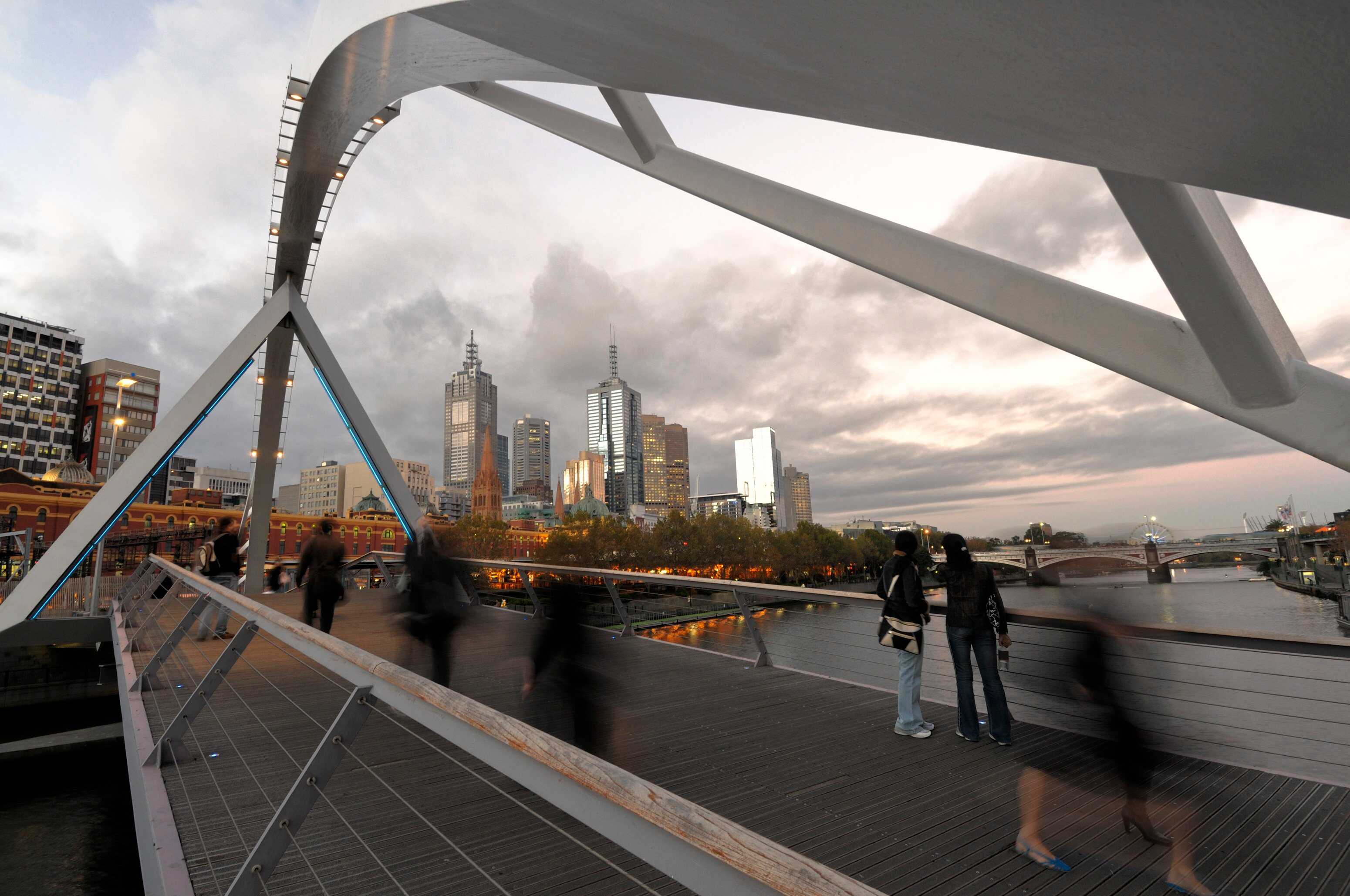 People stand on the Evan Walker Bridge over the Yarra River in Melbourne. Photo: Getty Images