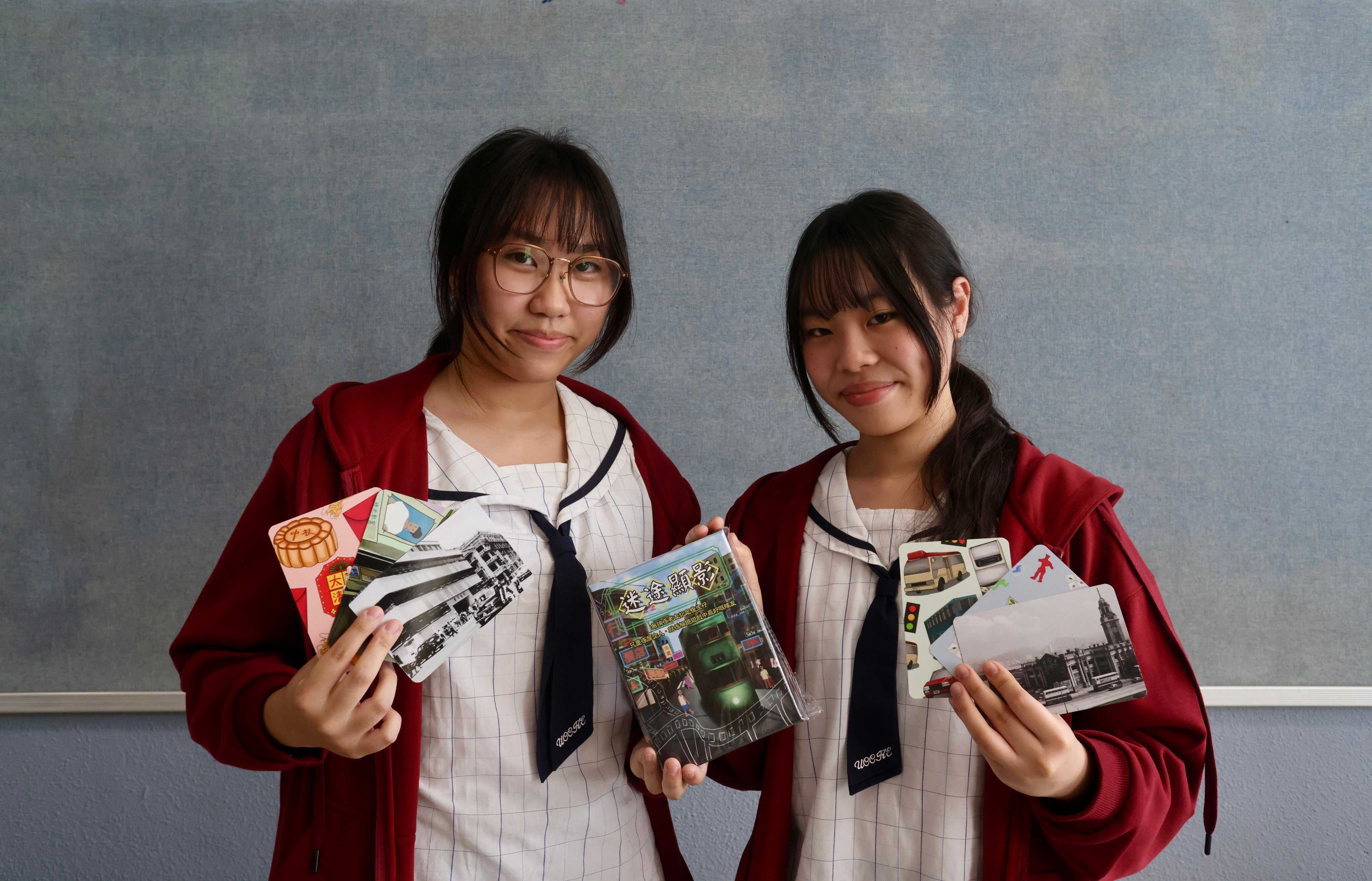 From left: United Christian College (Kowloon East) students Venus Hung Yat-yiu and Prudence Chung Sin-man pose with cards from their Lost and Found board game. Photo: Jonathan Wong
