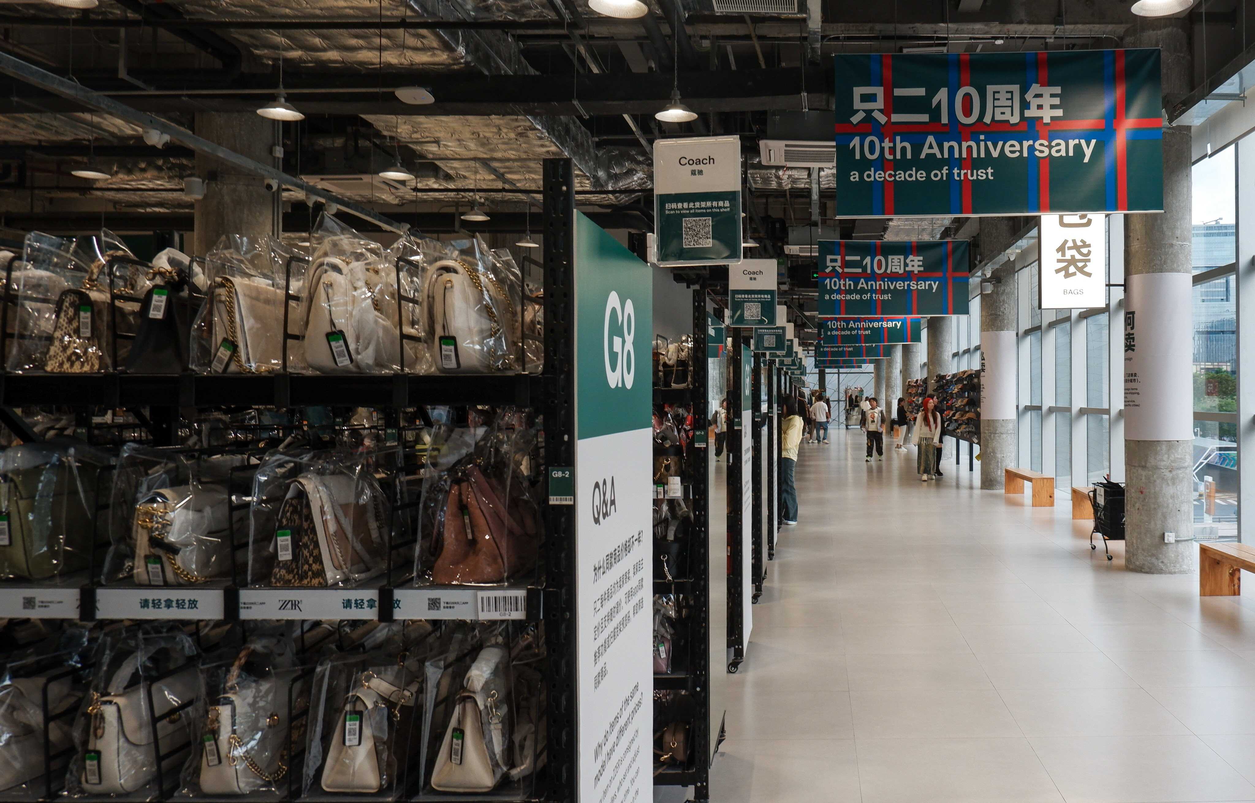 Second-hand luxury handbags at ZZER’s brick-and-mortar store in Shenzhen, China, are organised by brand, with each bag displayed in a transparent case. Photo: Alice Li
