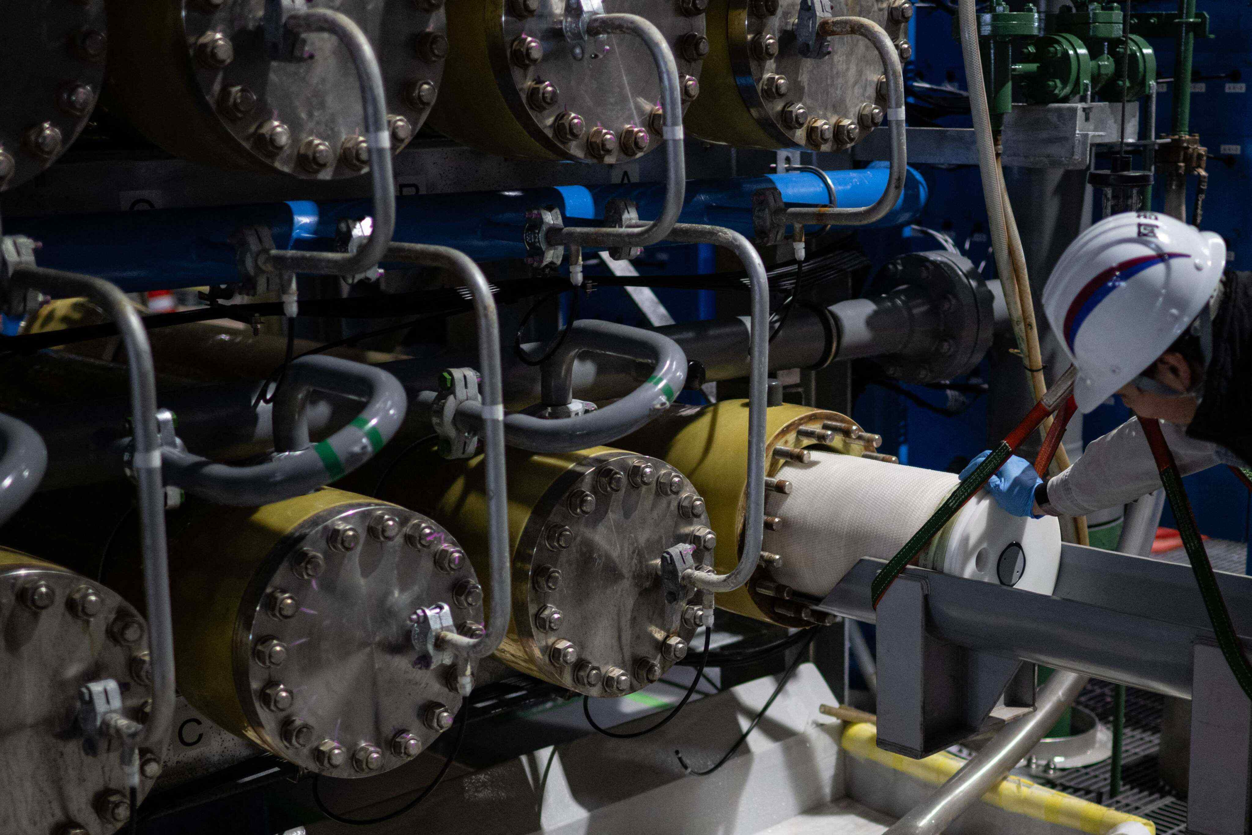 A staff member at the Sea Water Desalination Plant in Fukuoka changes part of the osmosis membrane facilities. Photo: AFP