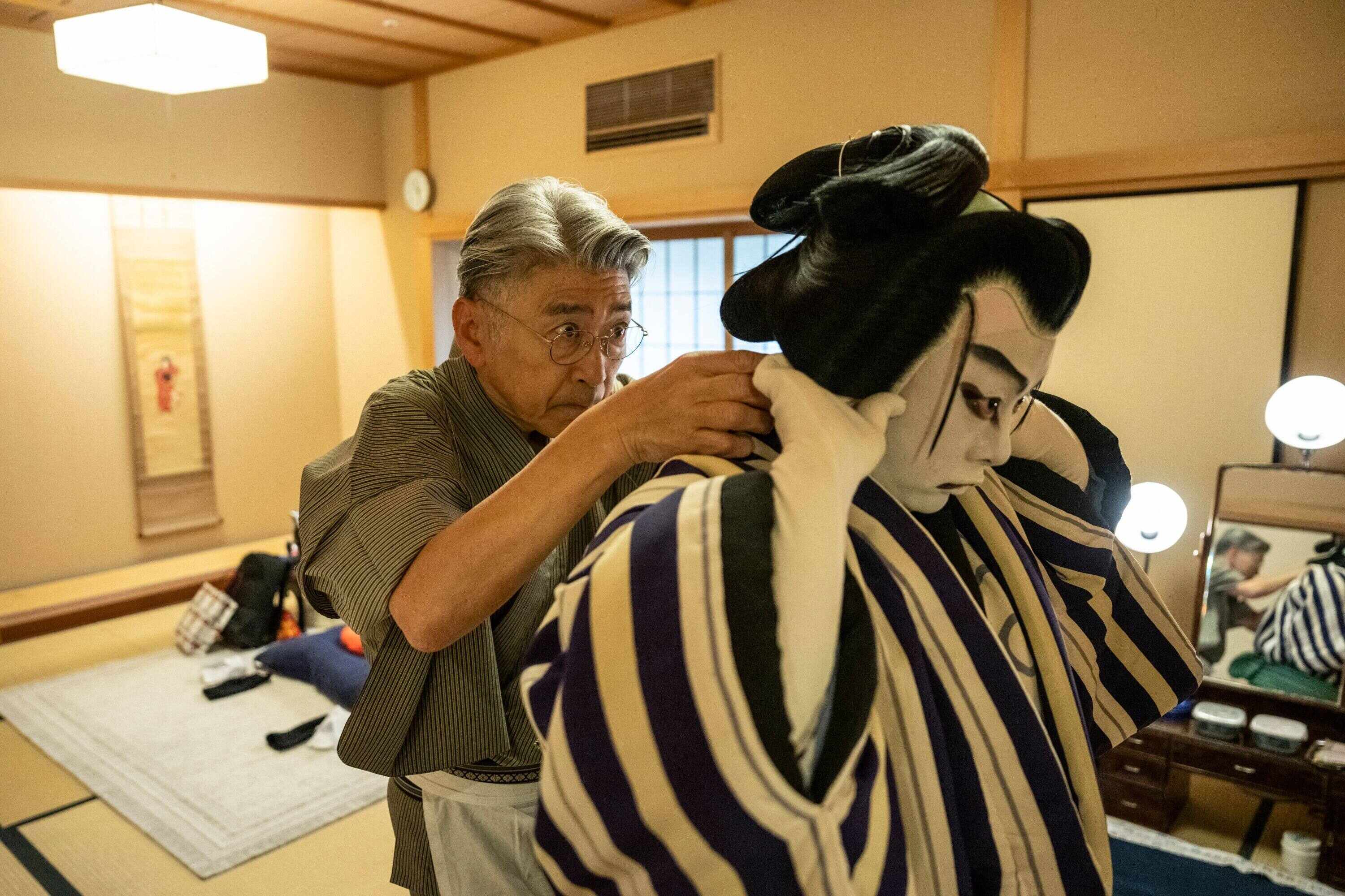 Kabuki wig master Tadashi Kamoji (left) helps kabuki actor Tanenosuke Nakamura put on his wig before a performance at the Kabuki-za Theatre in Tokyo. Photo: AFP