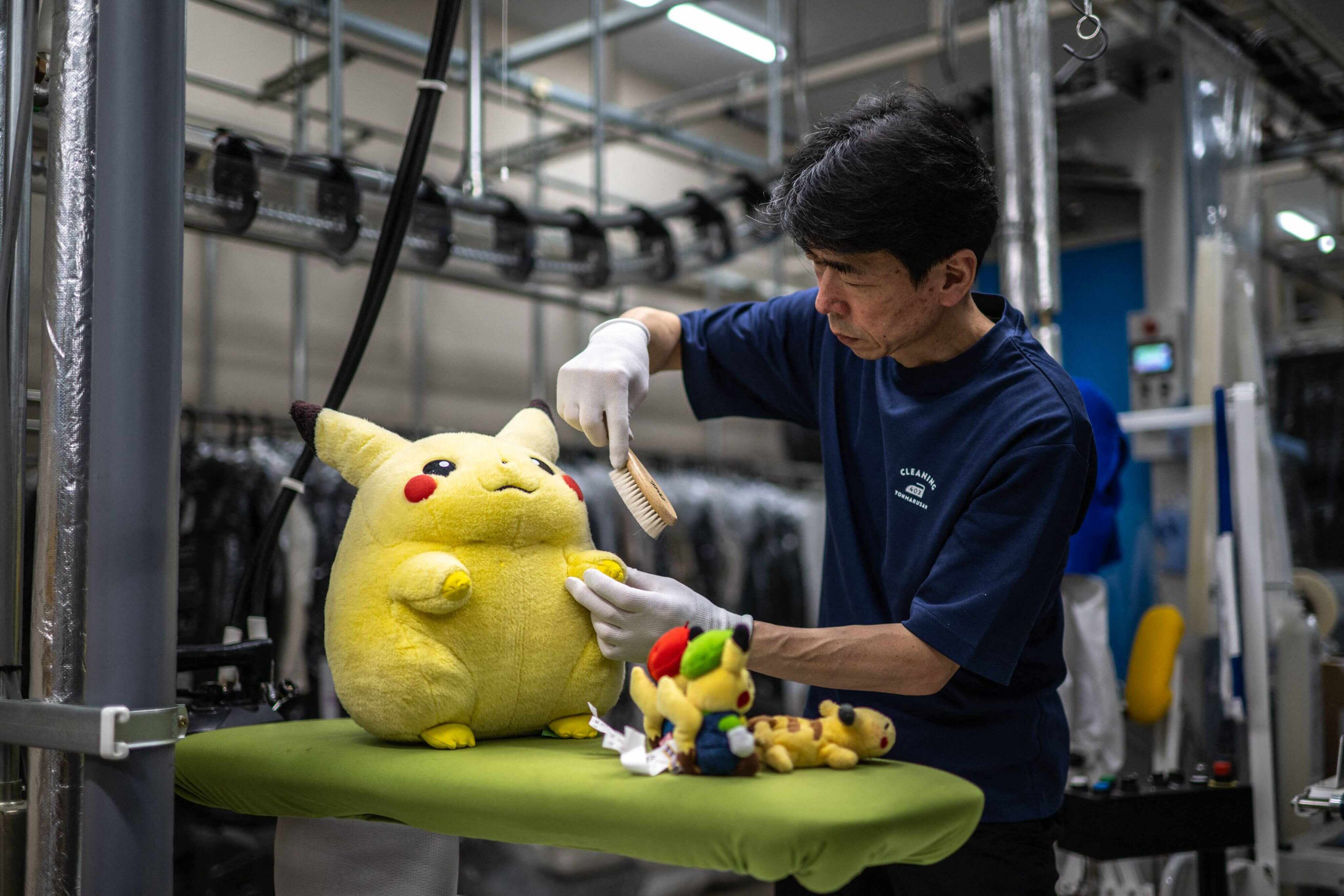 Masakazu Shimura brushes a Pikachu toy at Cleaning Yonmarusan in Fuefuki city, Yamanashi Prefecture, Japan. Photo: AFP