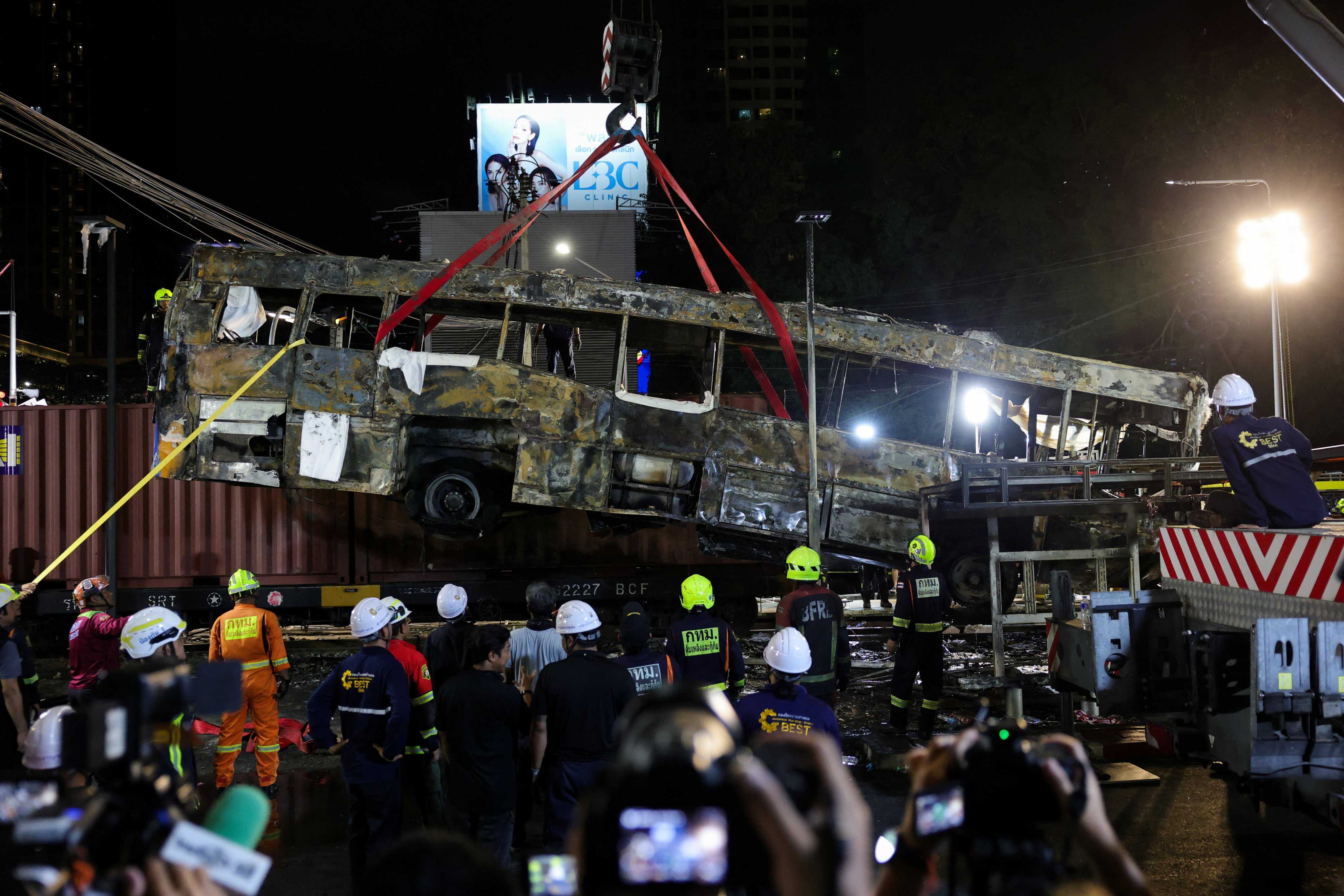 A crane lifts a bus that collided with a train and several cars on Asok-Din Daeng Road, causing several casualties, in Bangkok, Thailand, on May 16. Photo: Reuters