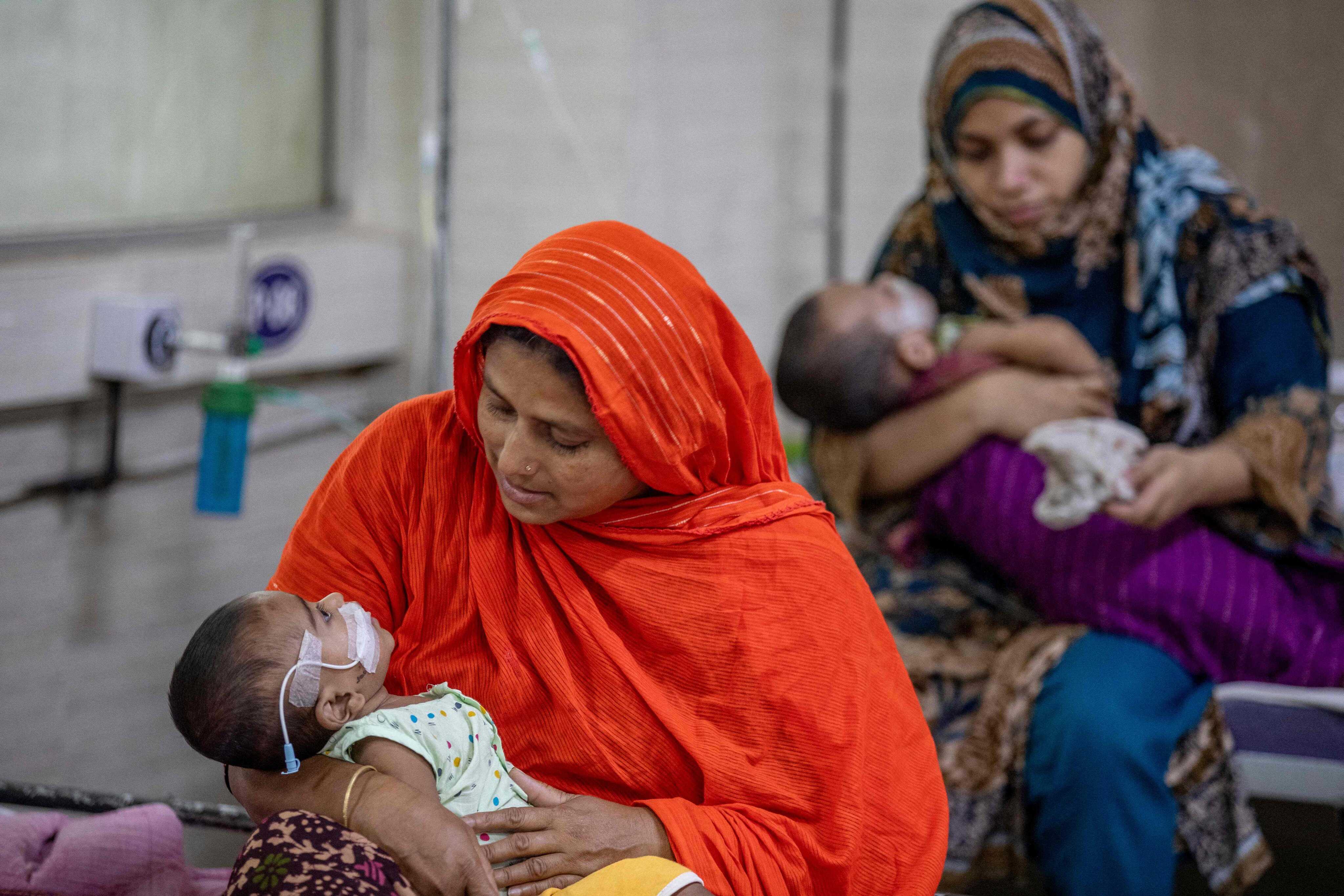 Women comfort children diagnosed with measles in a paediatric ward at the Bangladesh Shishu Hospital and Institute in Dhaka, Bangladesh. Photo: AFP