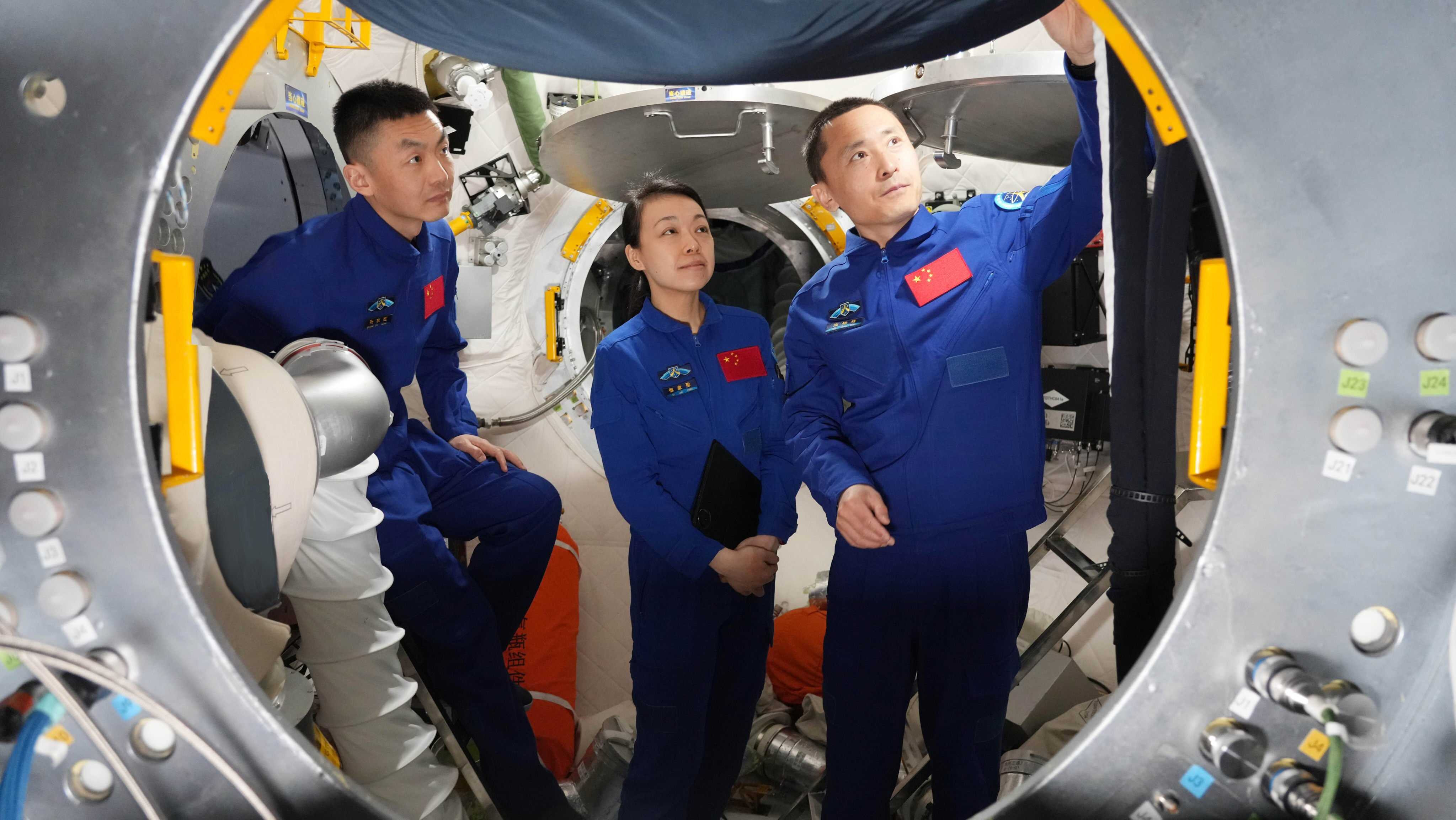 From left: Zhang Zhiyuan, Hong Kong’s first astronaut Lai Ka-ying, and Zhu Yangzhu at operational training on a combined vehicle simulator in April. Photo: Xinhua