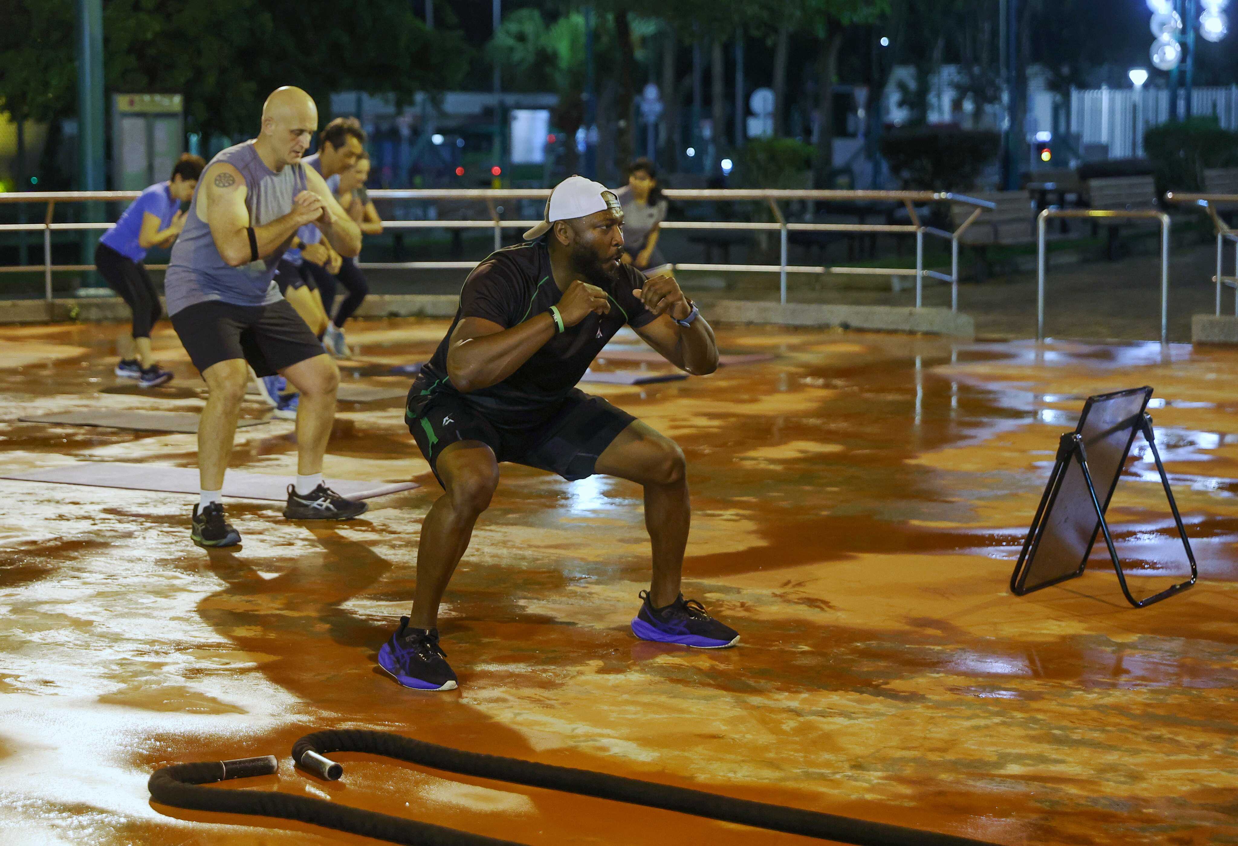 Fitness coach Ash Ayonote (right) leads a workout at Wai Man Road Playground in Sai Kung. Photo: Edmond So
