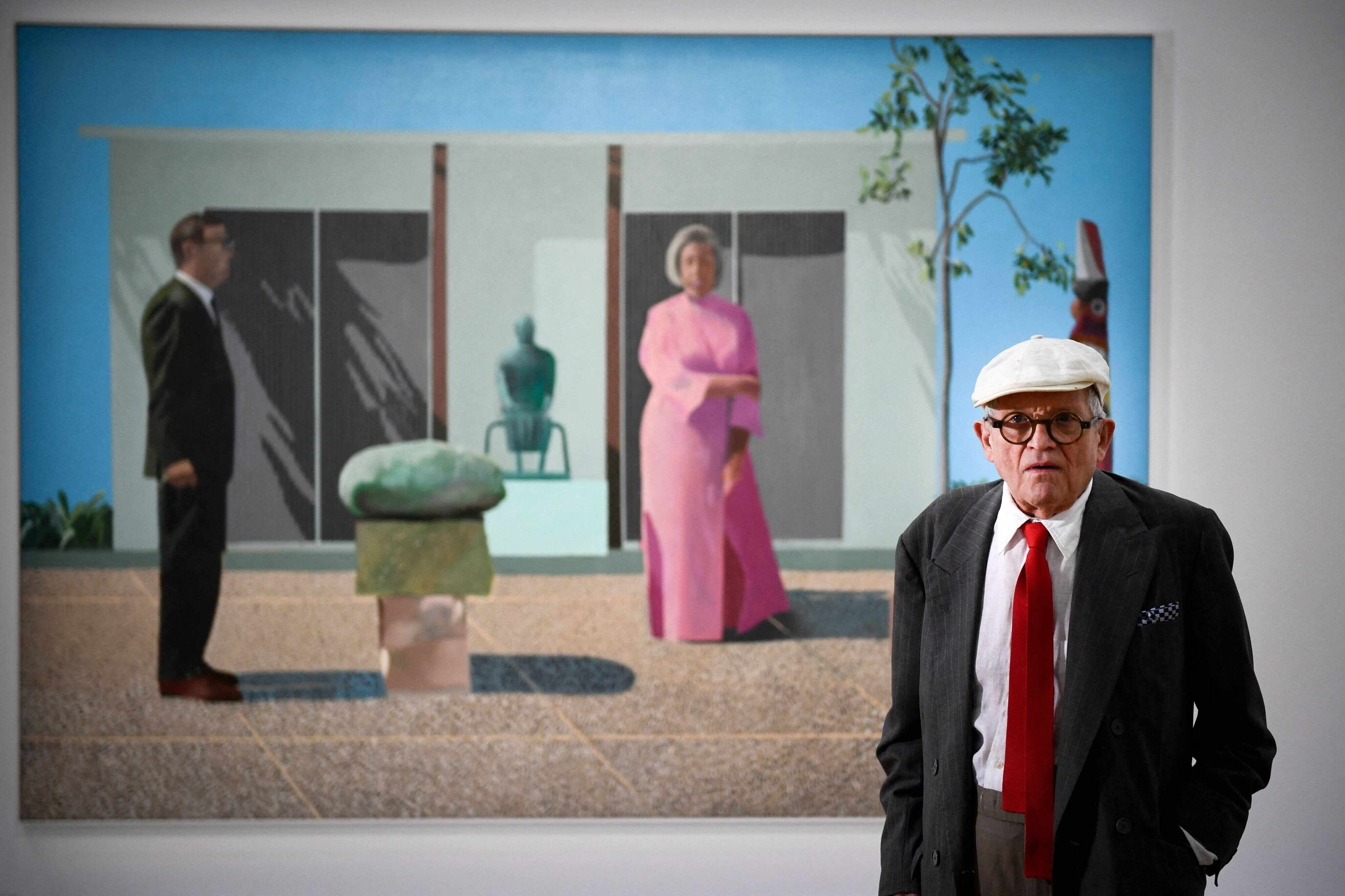 British artist David Hockney poses in front of his painting “Fred and Marcia Weisman” at the Pompidou Centre in Paris in June 2017. Photo: AFP
