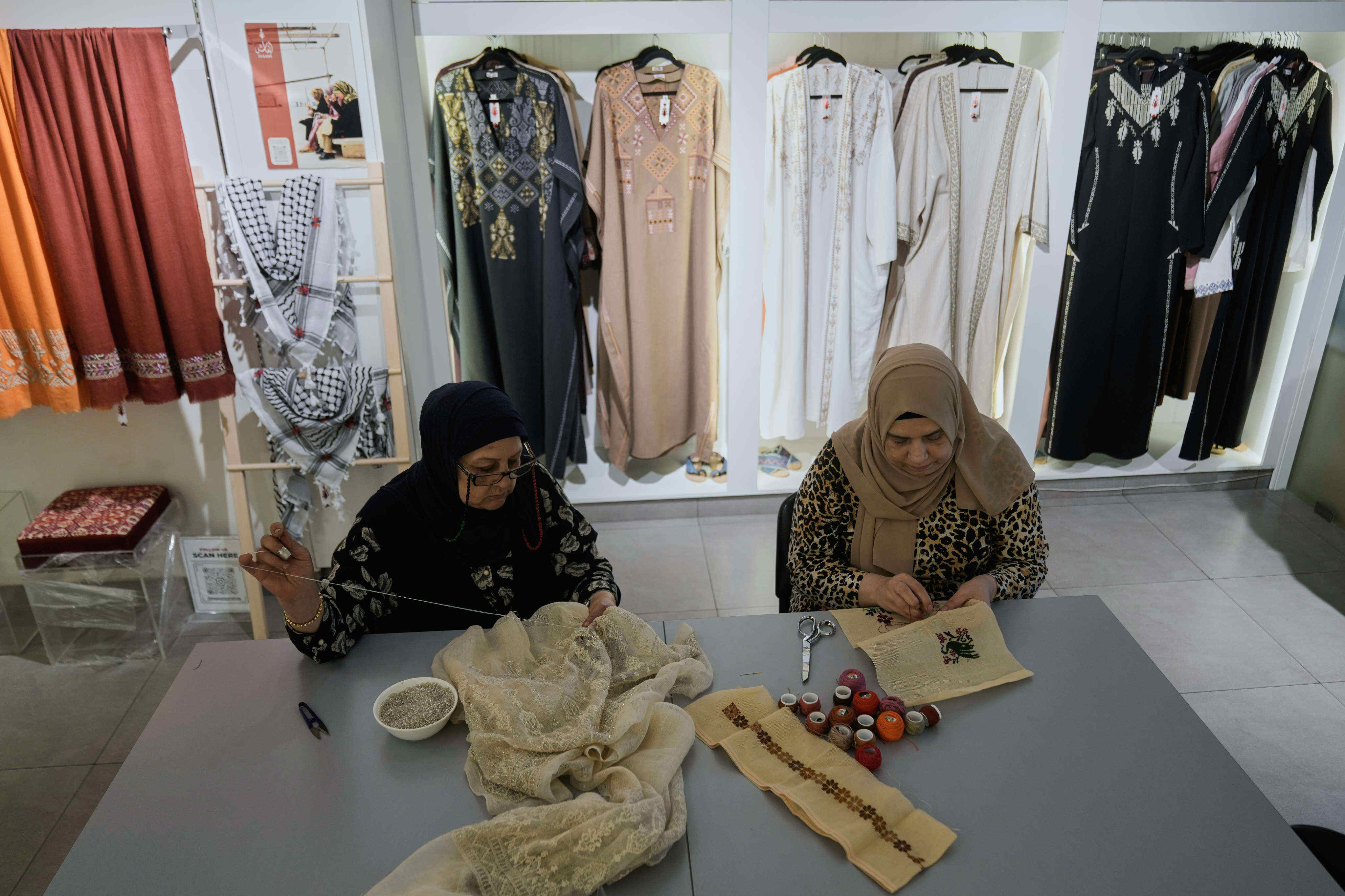 Palestinian weavers Rula Barakeh (right) and Samira Nasser work on handmade embroidered pieces at the Inaash Association embroidery workshop in Beirut, Lebanon. Photo: AP