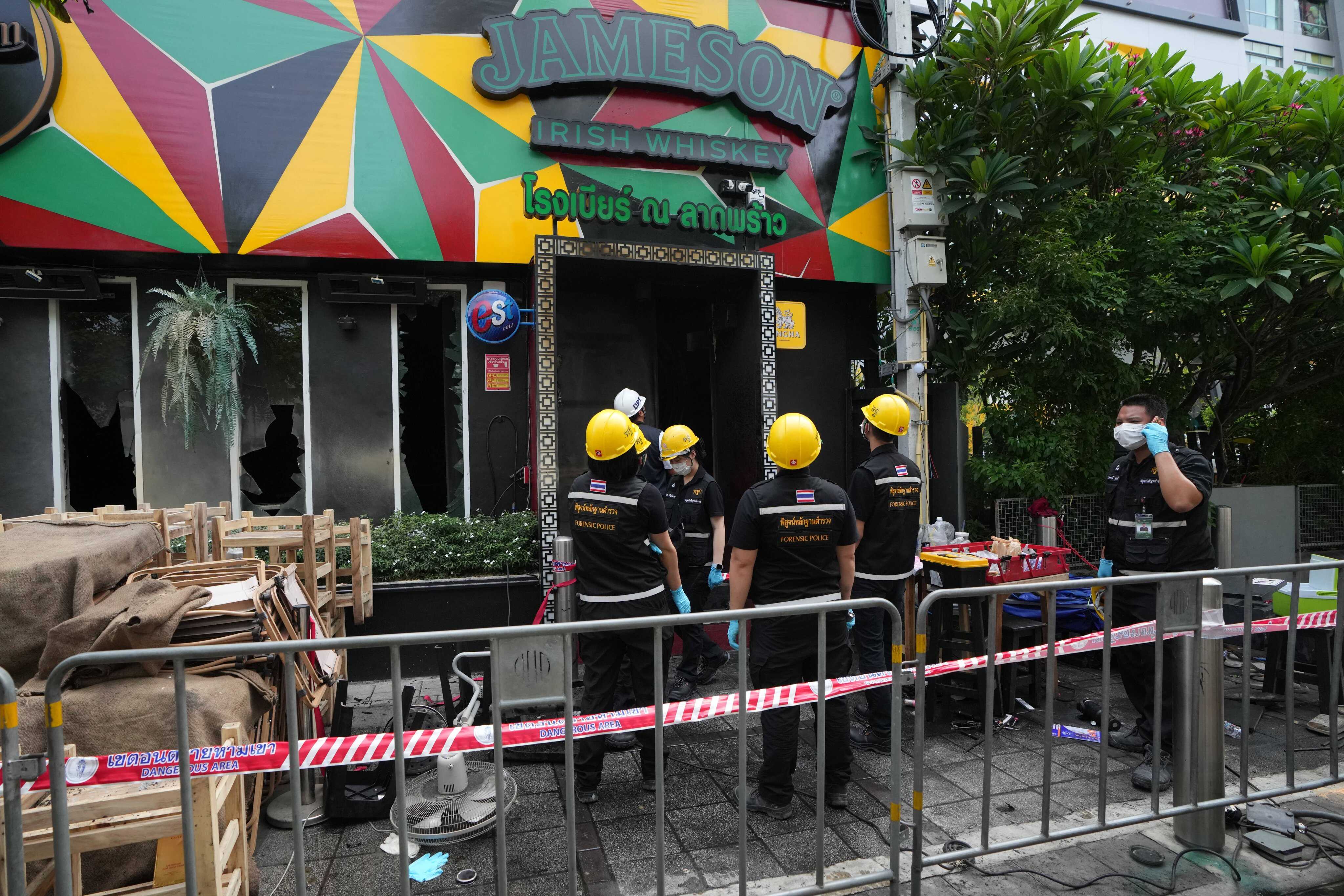 Forensic police officers inspect the site of the fire in Bangkok, Thailand. Photo: AP