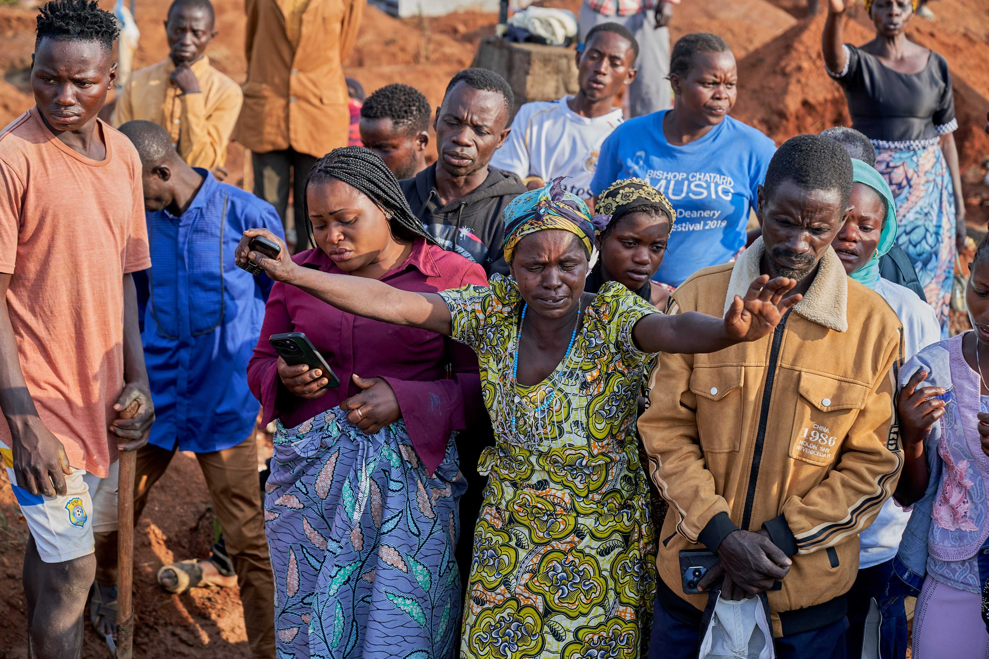 Relatives of Ebola victims react during a burial ceremony at a cemetery in Bunia, Ituri province, Democratic Republic of Congo on 22 July. Photo: EPA