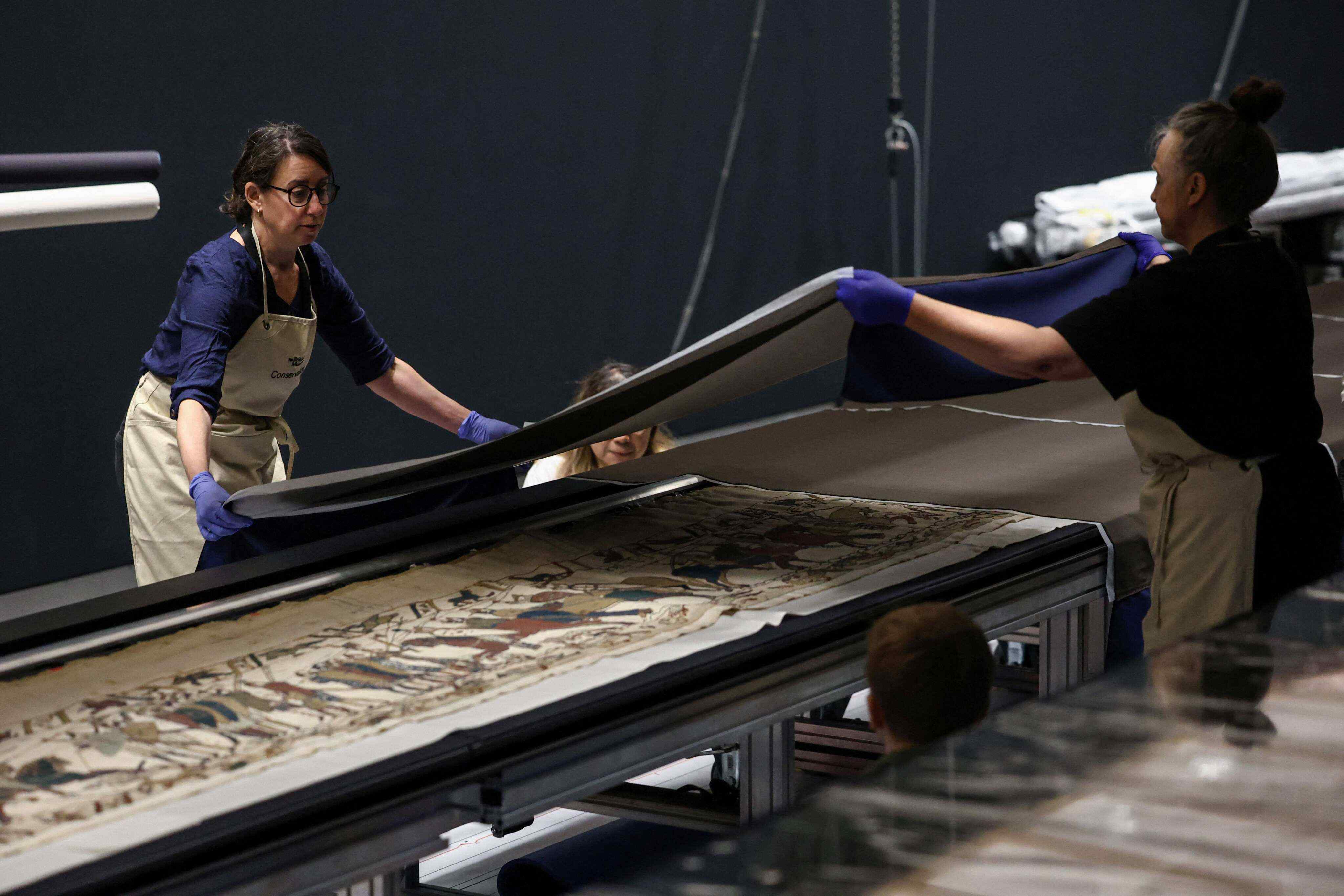 Museum staff work on unveiling the Bayeux Tapestry at the British Museum in London on July 17, 2026. Photo: AFP