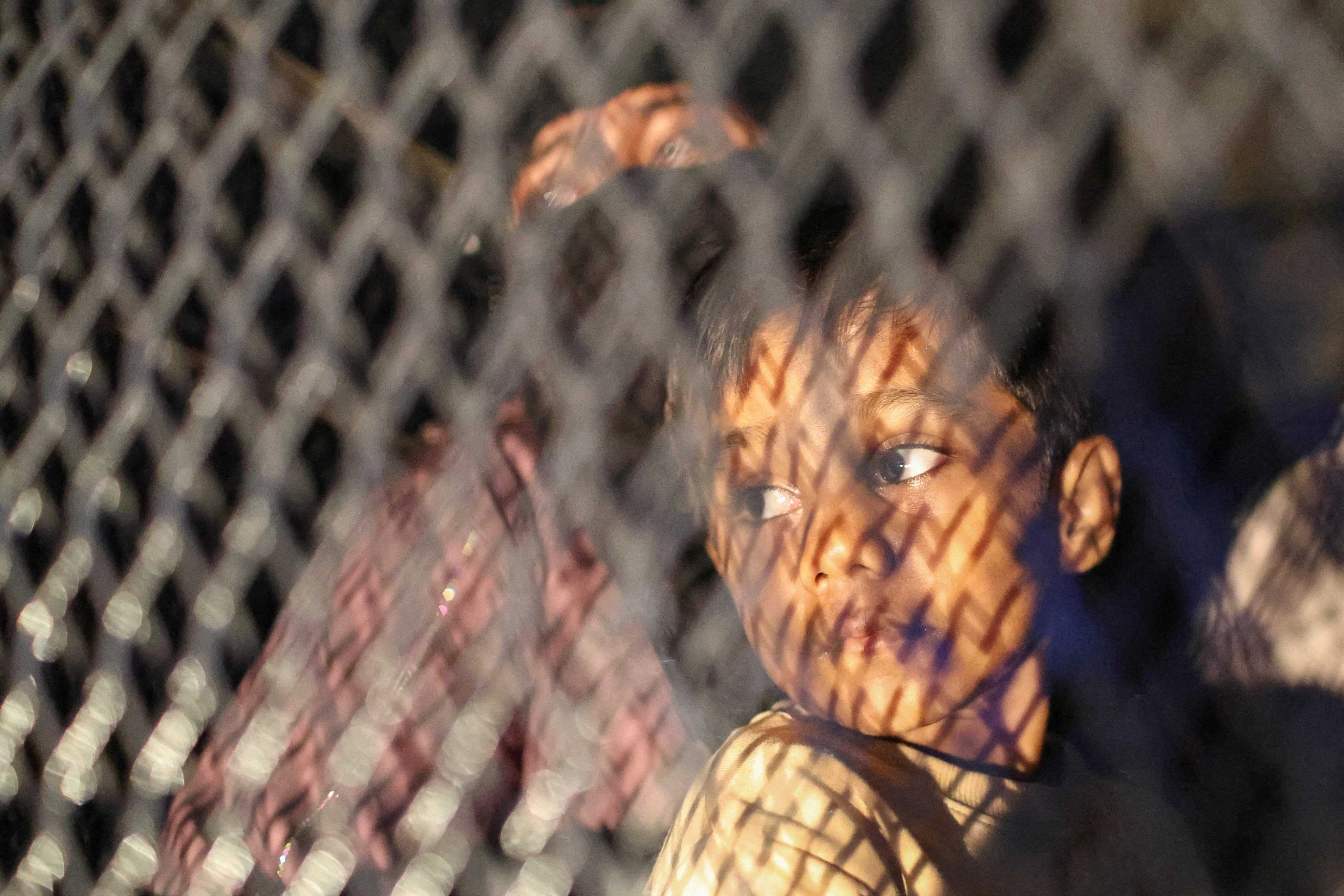 Rohingya refugees sit inside a truck as they are taken by police after being evicted from their homes in Kuala Lumpur, Malaysia. Photo: Reuters