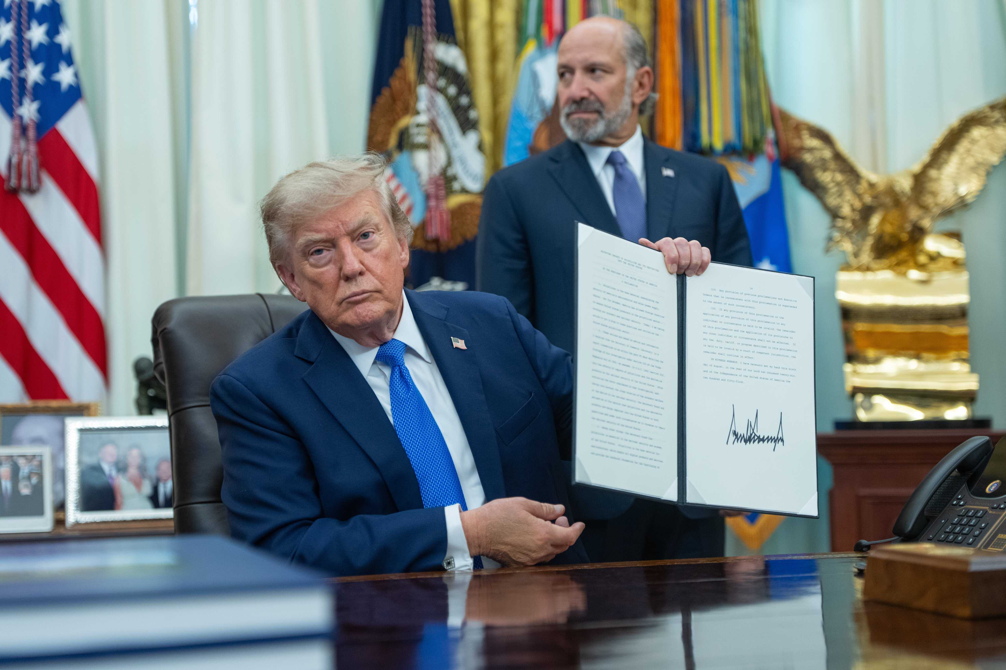 US President Donald Trump displays an executive order aiming to curtail “birth tourism” and birthright citizenship despite a Supreme Court opinion earlier this summer. Photo: EPA