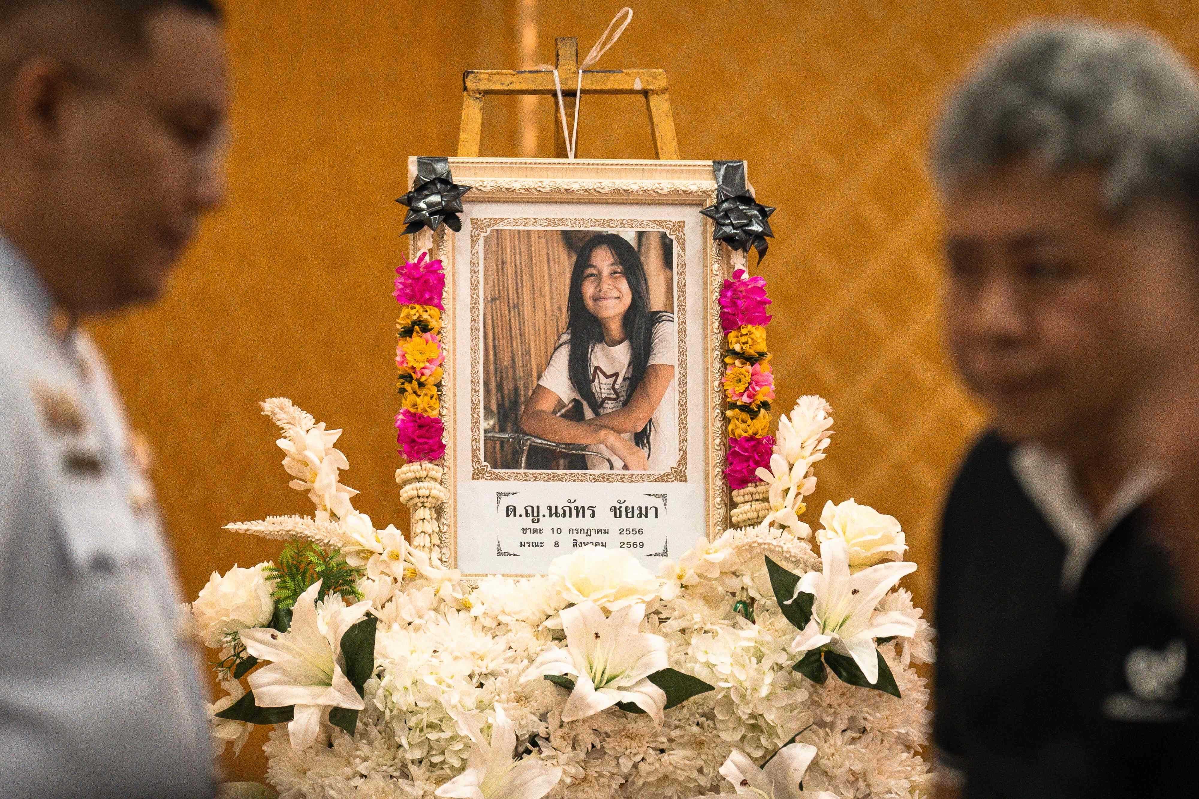 A portrait of 12-year-old school shooting victim Naphat Chaima is displayed during her funeral at the Wat Lat Pla Duk Buddhist temple in Nonthaburi province, north of Thailand’s capital Bangkok, on August 9, 2026. A teenage assailant shot his grandparents, using his grandfather’s handgun, at their home north of Bangkok on August 7 before going on a killing spree at his secondary school and ultimately turning the gun on himself, according to authorities. Photo: AFP