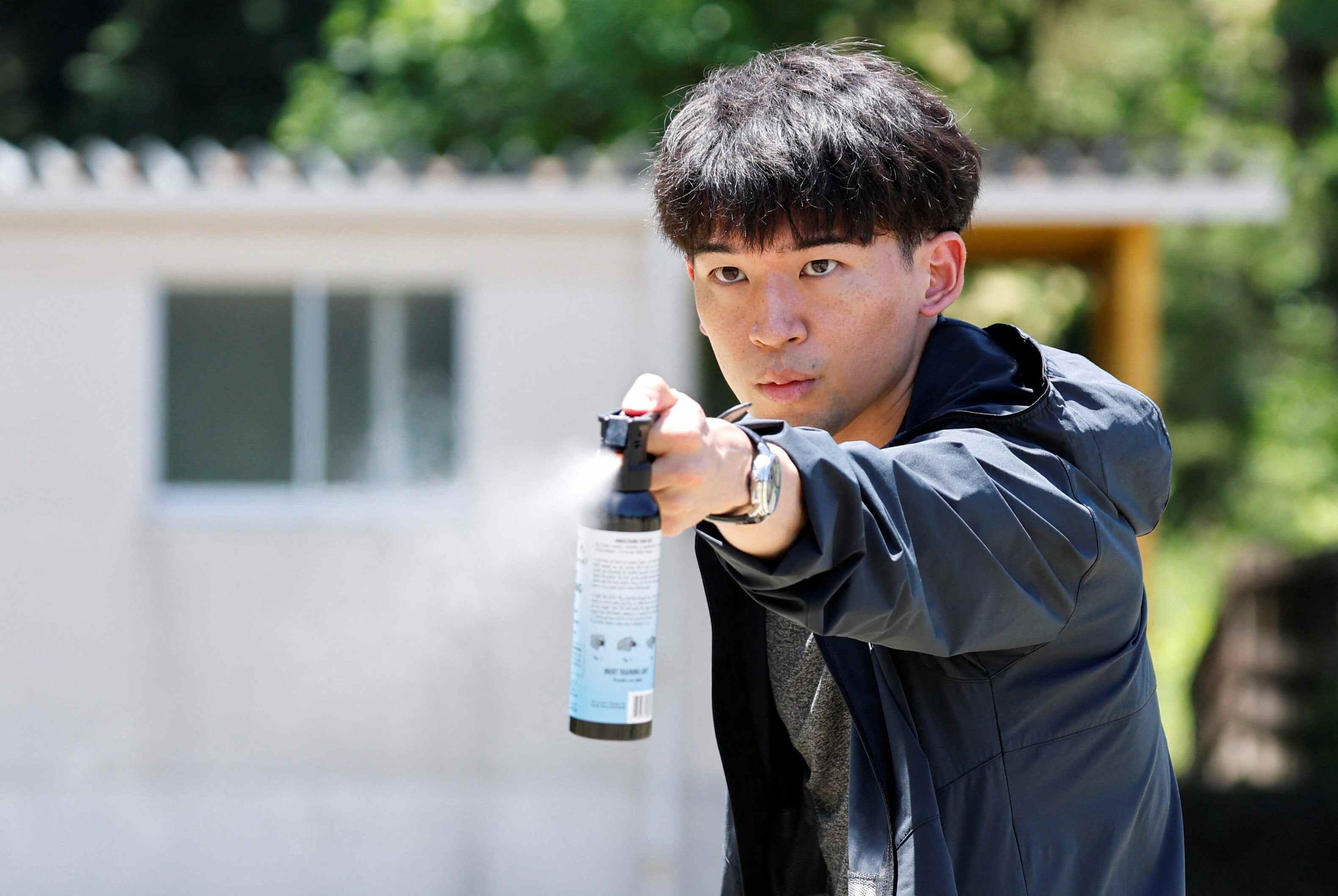 An anti-bear spray is used during an emergency drill in Japan. Photo: Reuters