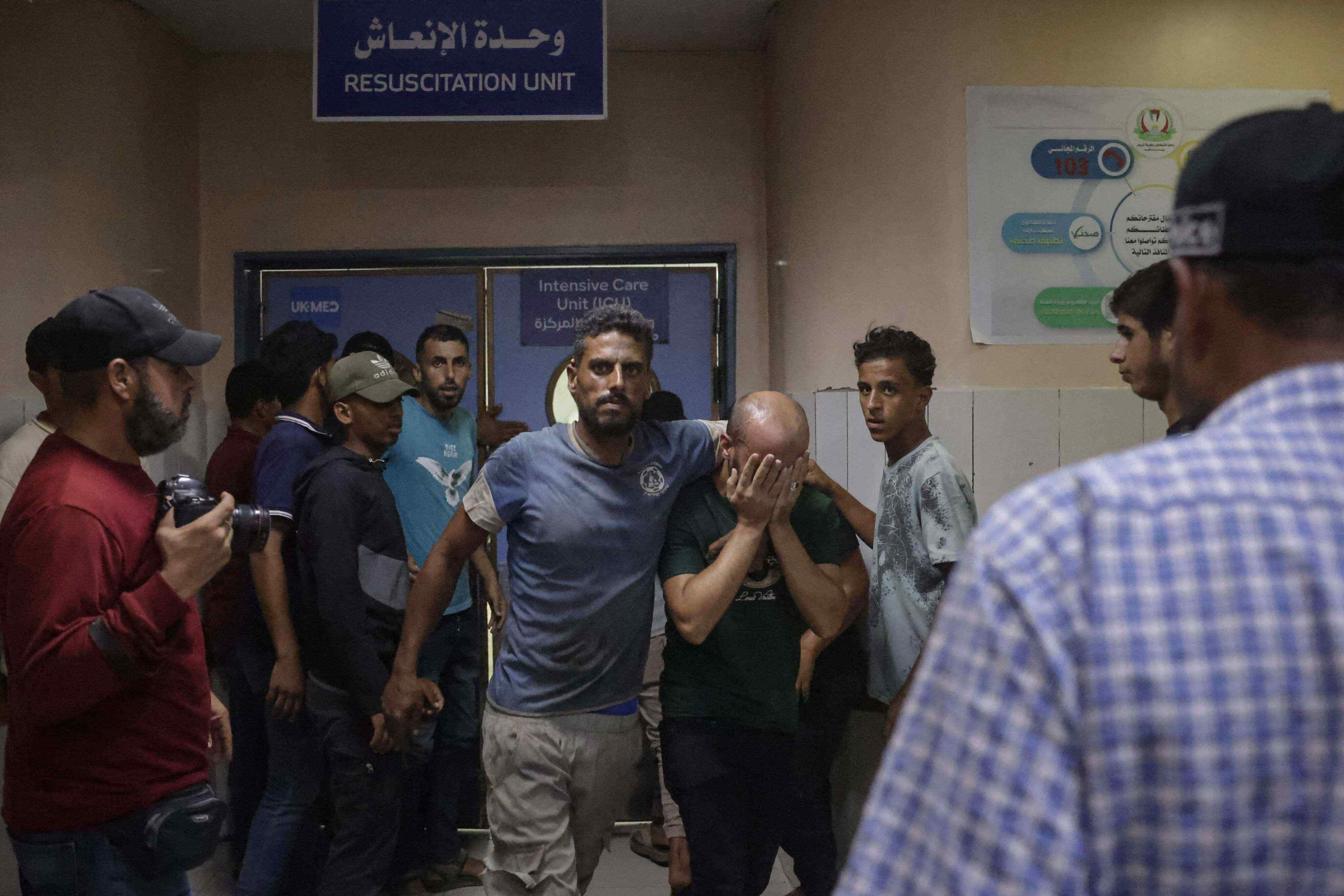 A Palestinian man grieves during the funeral of Huthaifa Kawari who, according to health officials was killed in an Israeli strike at Nasser Hospital in Khan Yunis, southern Gaza strip, on August 13, 2026. Photo: AFP