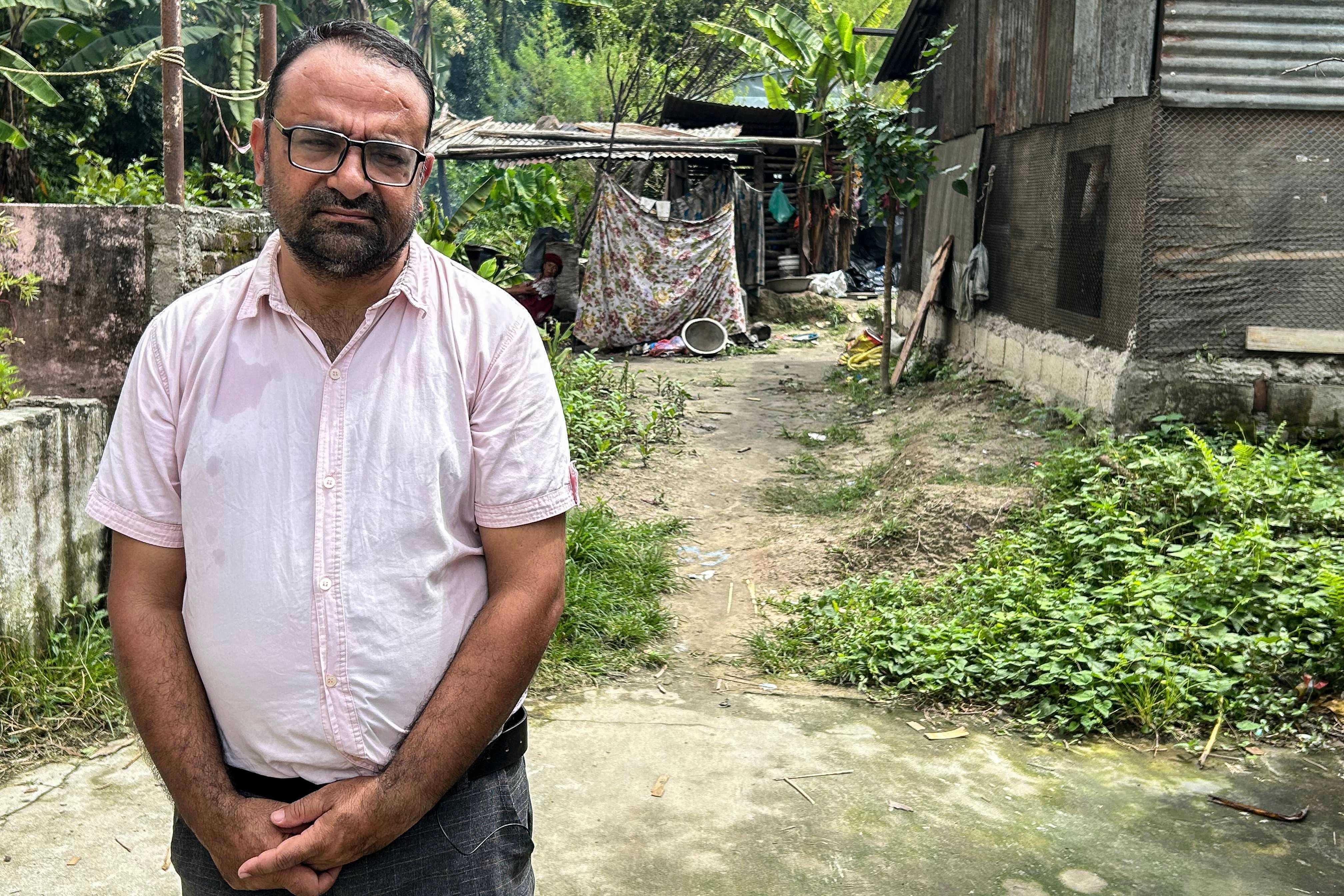 Rajendra Dawadi, 47, principal of the Trishuli Bazaar Secondary School, poses for a photograph in a garden next to his home in Nepal’s Nuwakot District. Photo: AFP