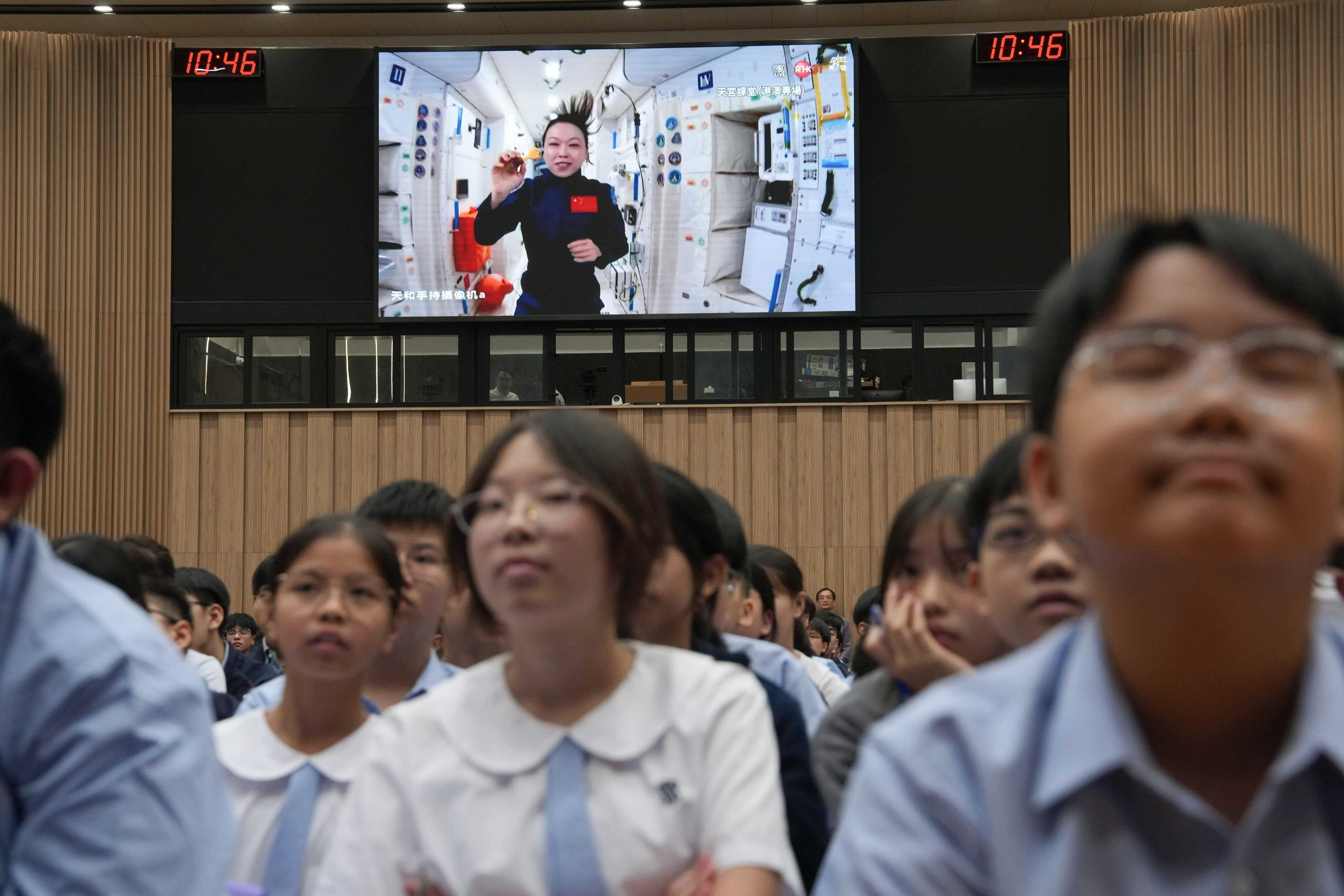 At Scientia Secondary School, students watch a live lecture by astronaut Lai Ka-ying from space. Photo: Sam Tsang