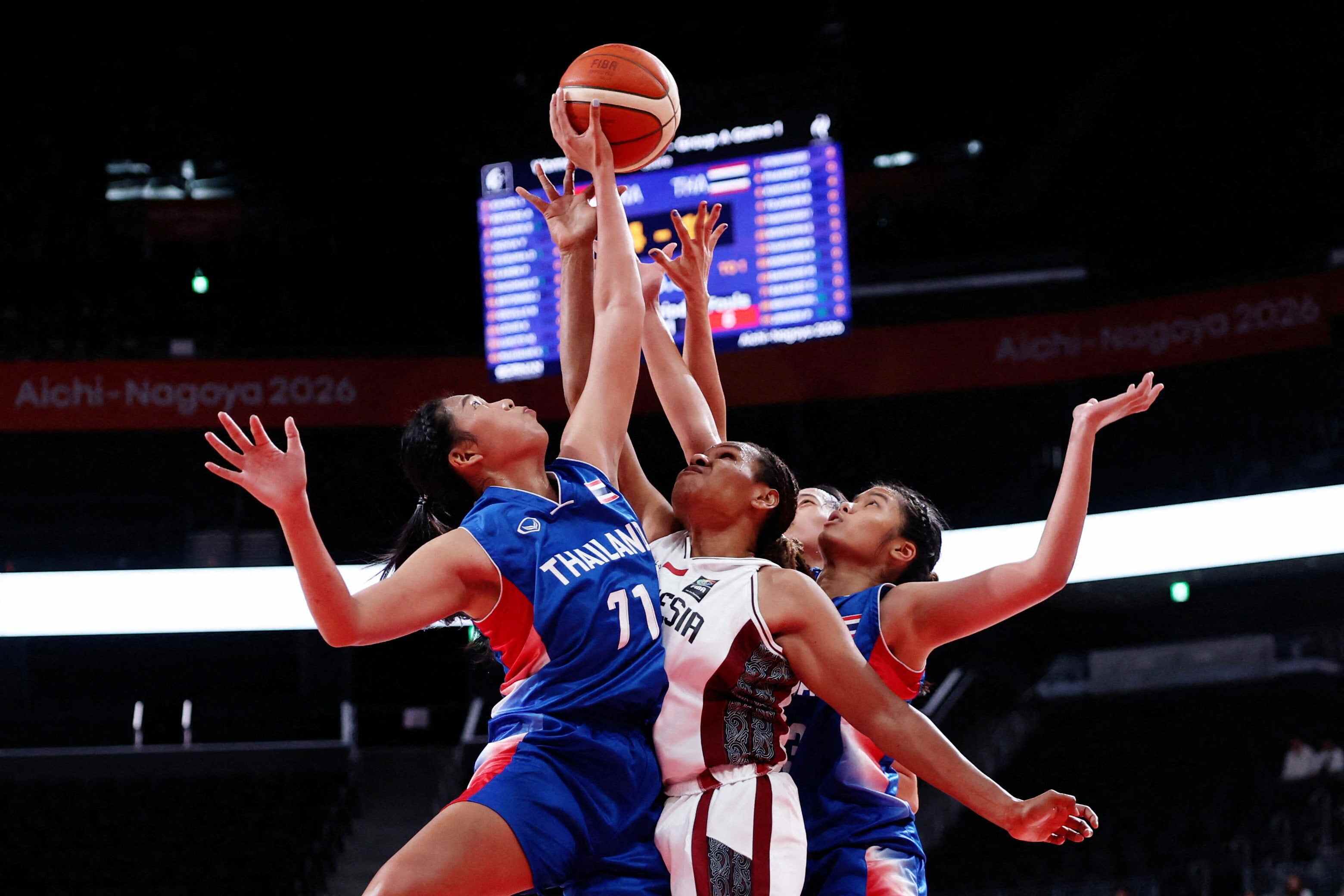 During a basketball game, Thailand’s Chosita Sakaret (left) faces off with Indonesia’s Lea Kahol. Photo: Reuters