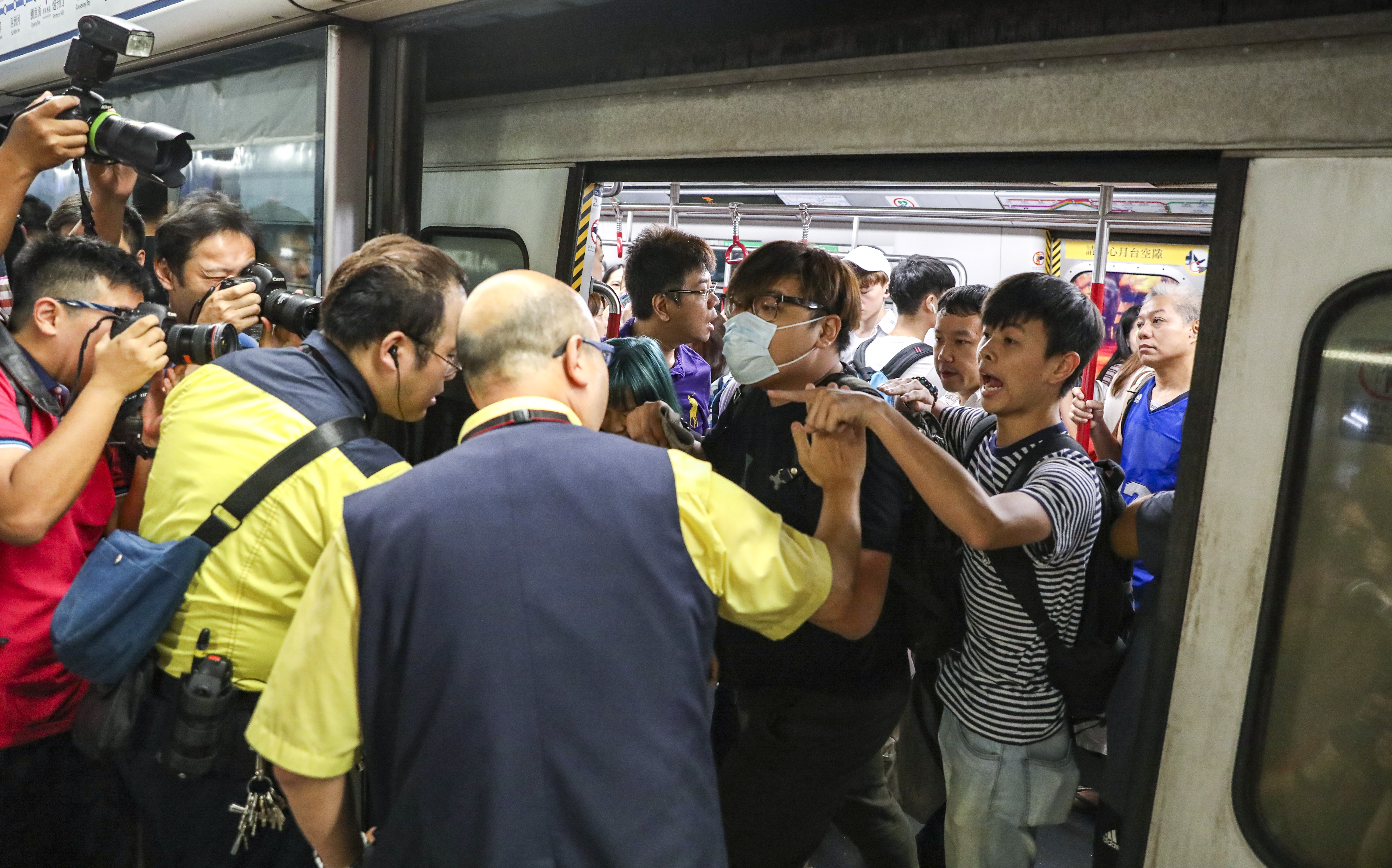 HK protests: Rush hour chaos as protesters block train doors | Young ...