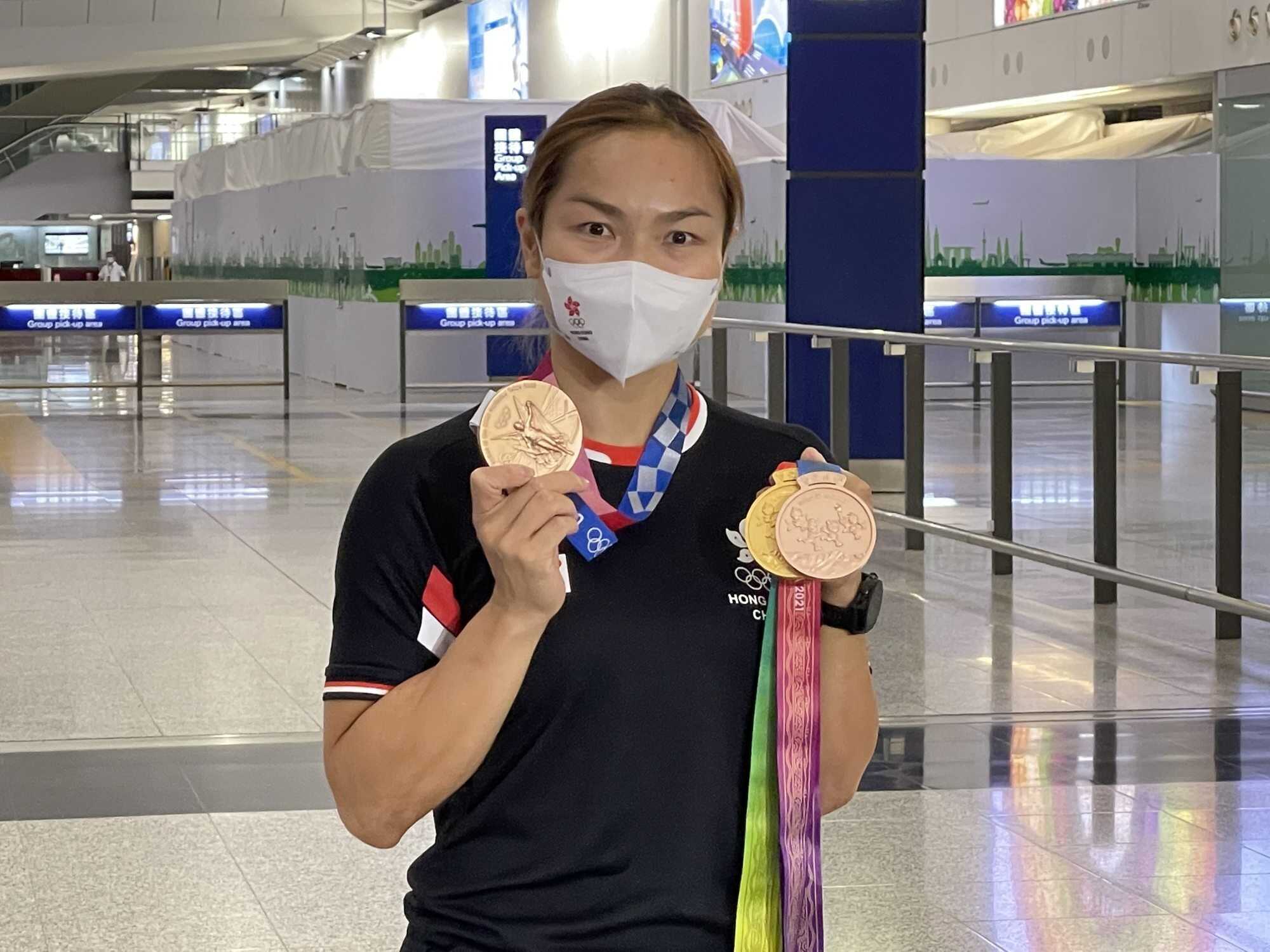Sarah Lee Wai-sze poses with her medals from the Tokyo Olympics and the National Games. Photo: Chan Kin-wa
