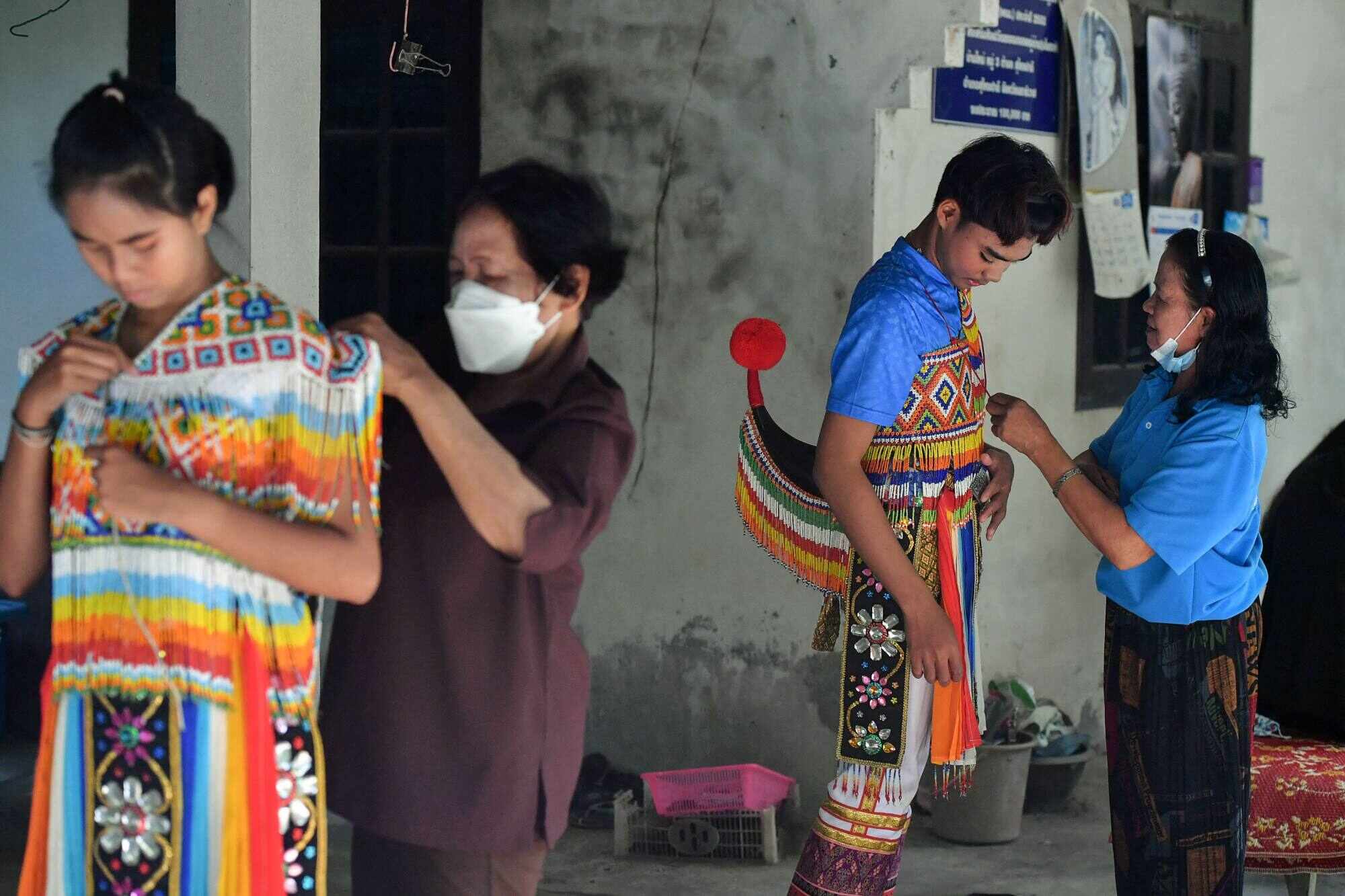 Dancers getting ready to take part in a “nora” performance. Photo: AFP
