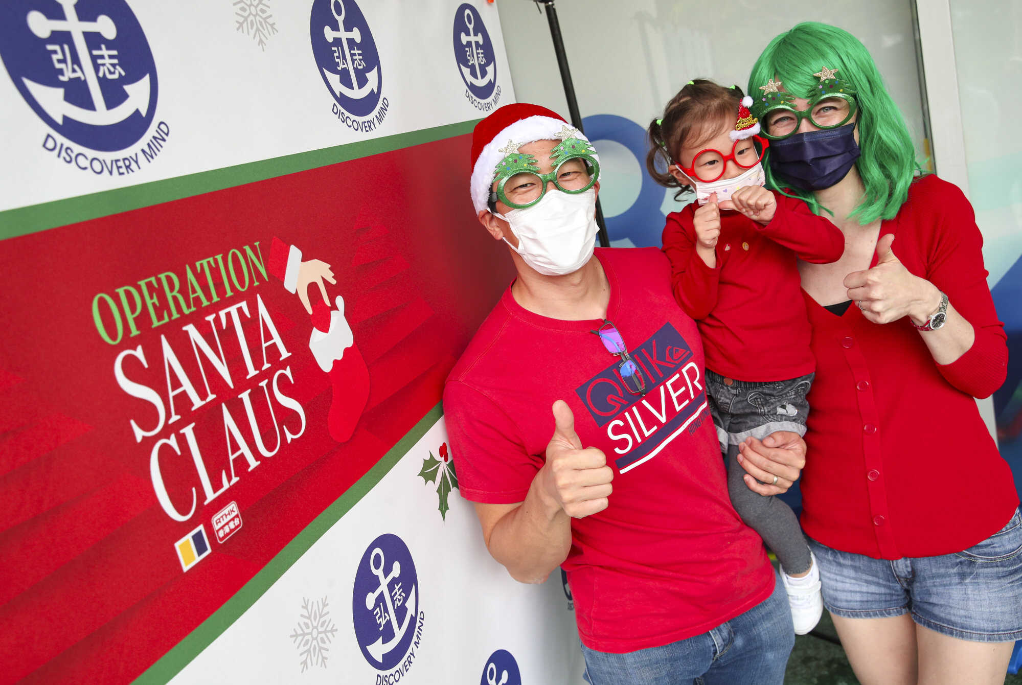 (L to R) Father Sammie Chan, Mother Suzanne Chan and daughter Elodie Chan pose for a picture during Operation Santa Claus celebrations. Photo: SCMP/ Edmond So
