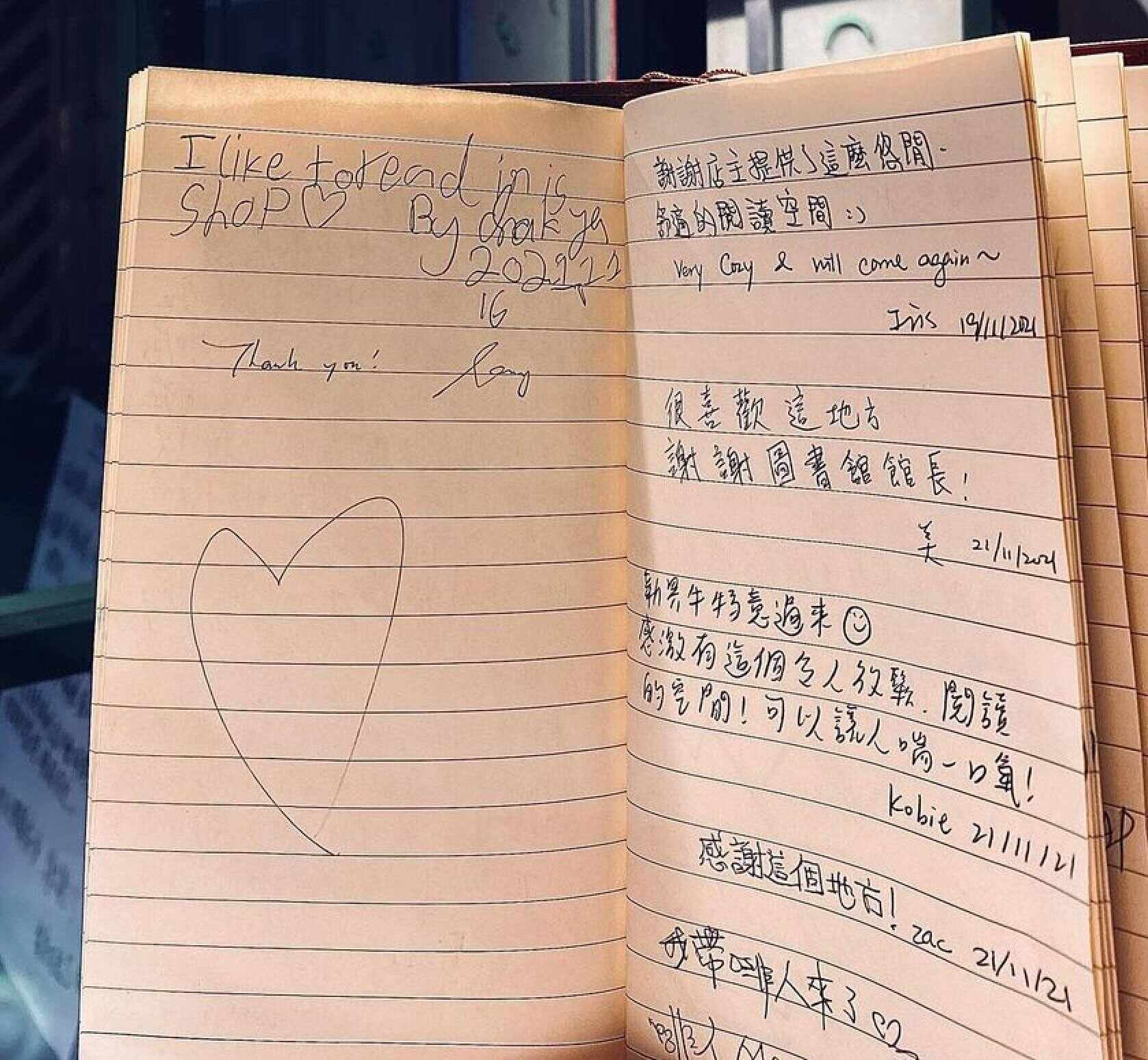 Visitors write comments in the guestbook to show their appreciation for Traces of Books. Photo: Traces of Books