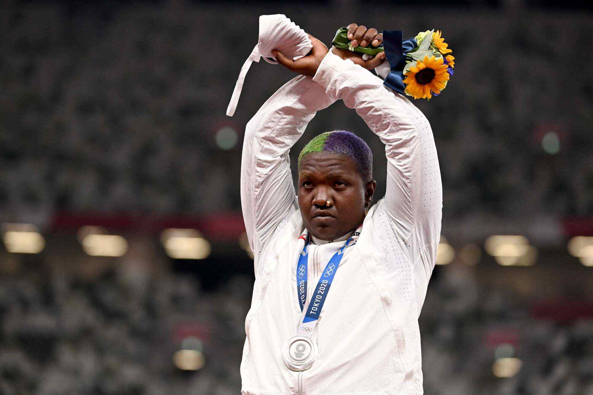 During the 2020 Tokyo Games, Raven Saunders raises her arms in an “X” gesture on the podium to symbolise oppression. Photo: AFP