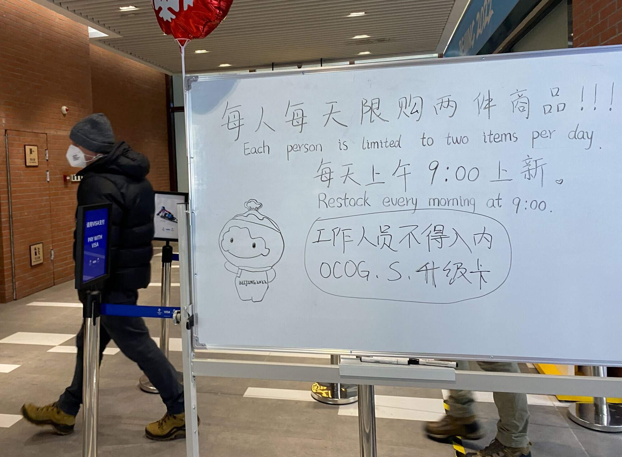 A note on a whiteboard outside an Olympics souvenir shop telling customers that they are allowed to buy two Bing Dwen Dwen items every day due to supply shortage. Photo: Reuters
