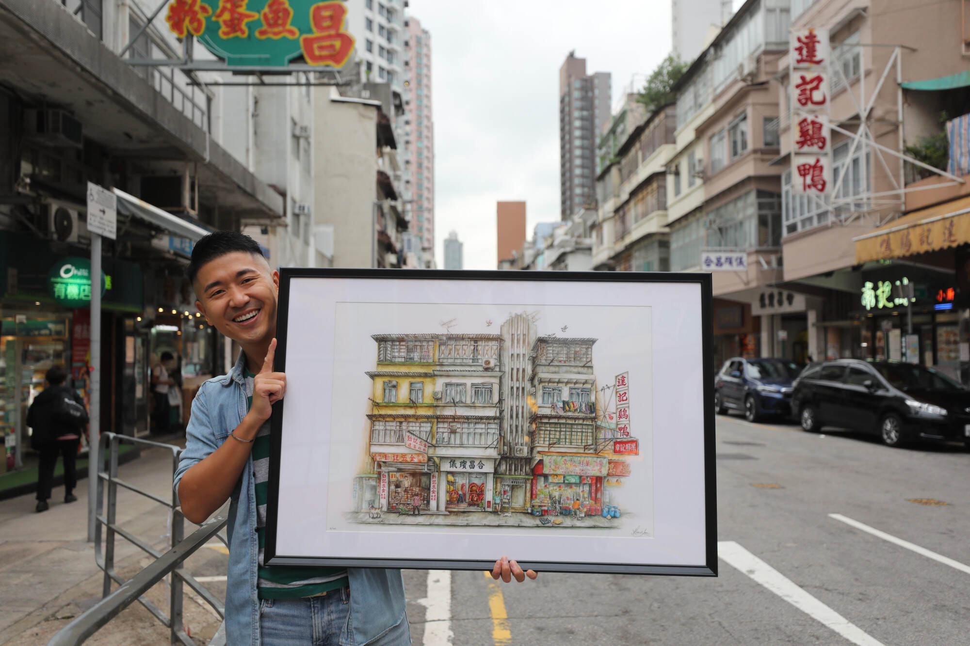 Hong Kong artist Alvin Lam poses with one of his watercolour urban sketches. Photo: Xiaomei Chen