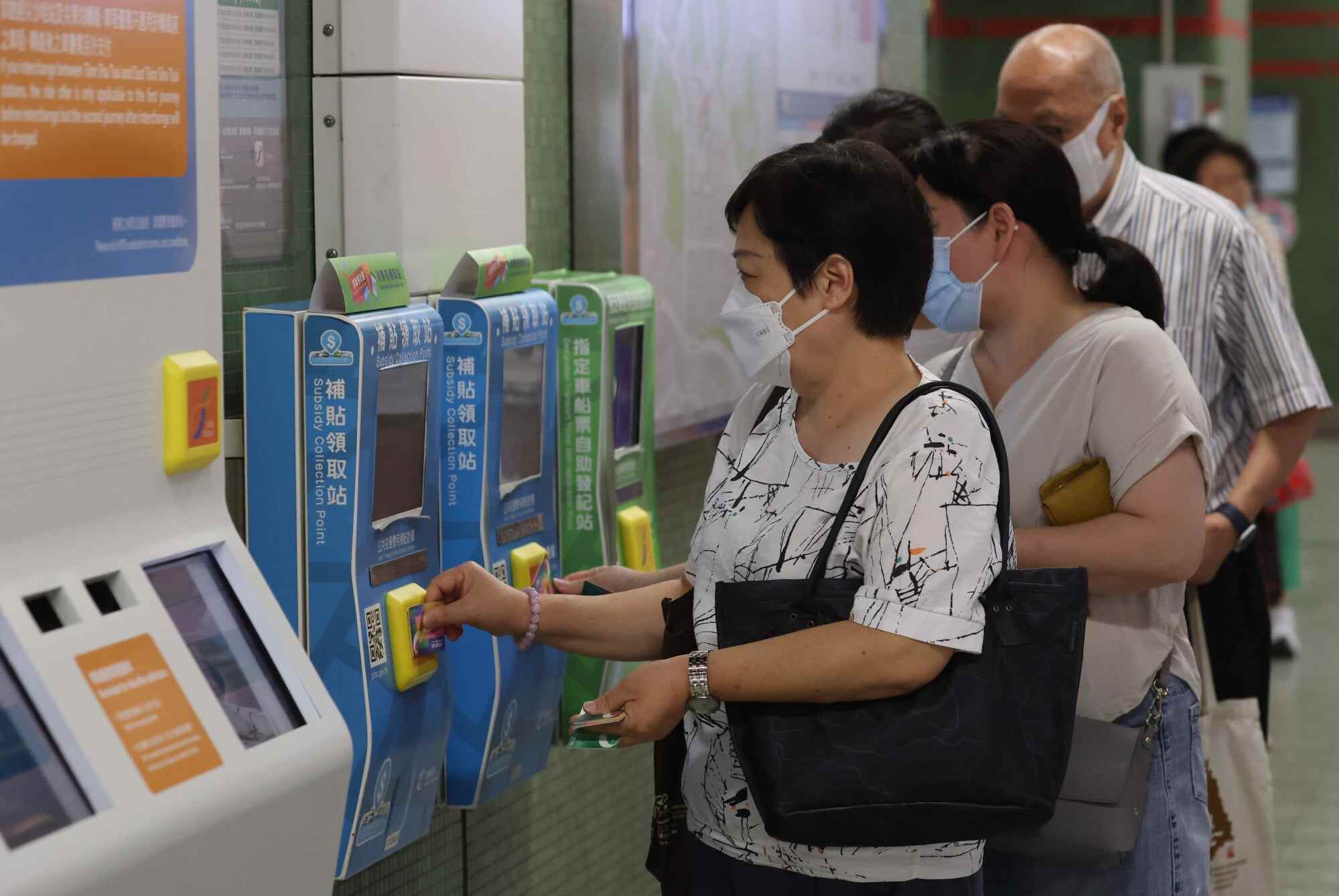 People line up to collect their consumption vouchers. Photo: Edmond So