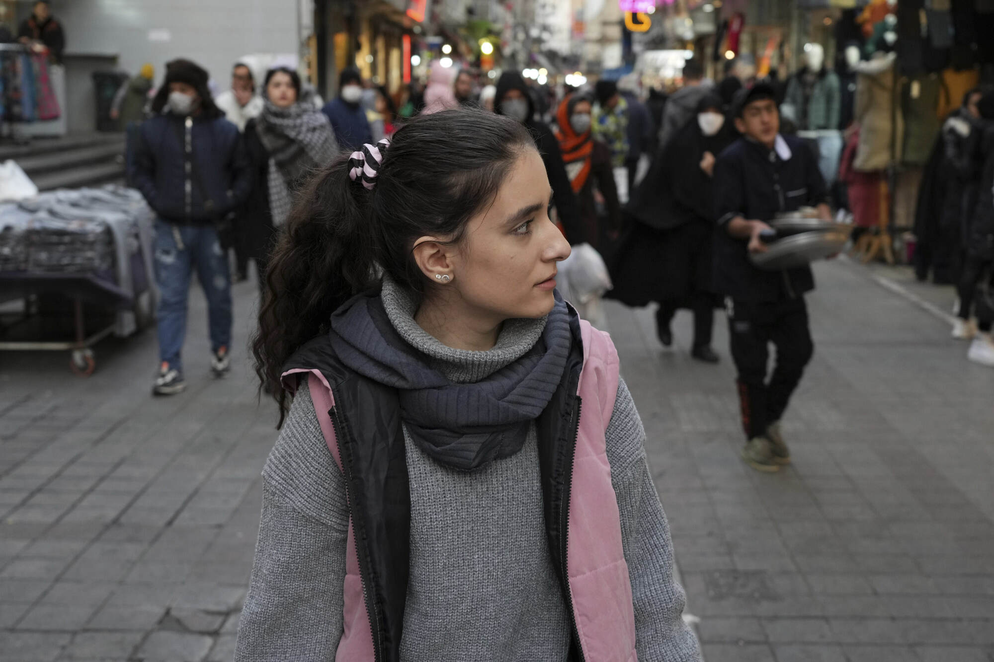 A woman walks around without wearing her mandatory headscarf in downtown Tehran, Iran, on December 23, 2022. Iran has been gripped by nationwide protests since September, after the death of a young woman who died while under custody by the morality police for allegedly not observing the mandatory Islamic hijab. Photo: AP