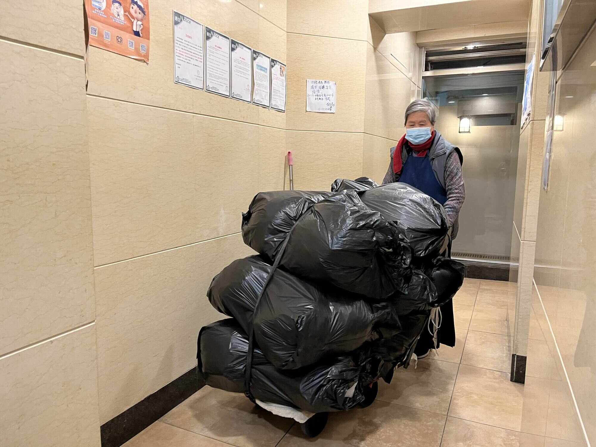 Gwai*, 80, has been cleaning two residential buildings in Sai Wan for the past 32 years. Photo: Kelly Fung